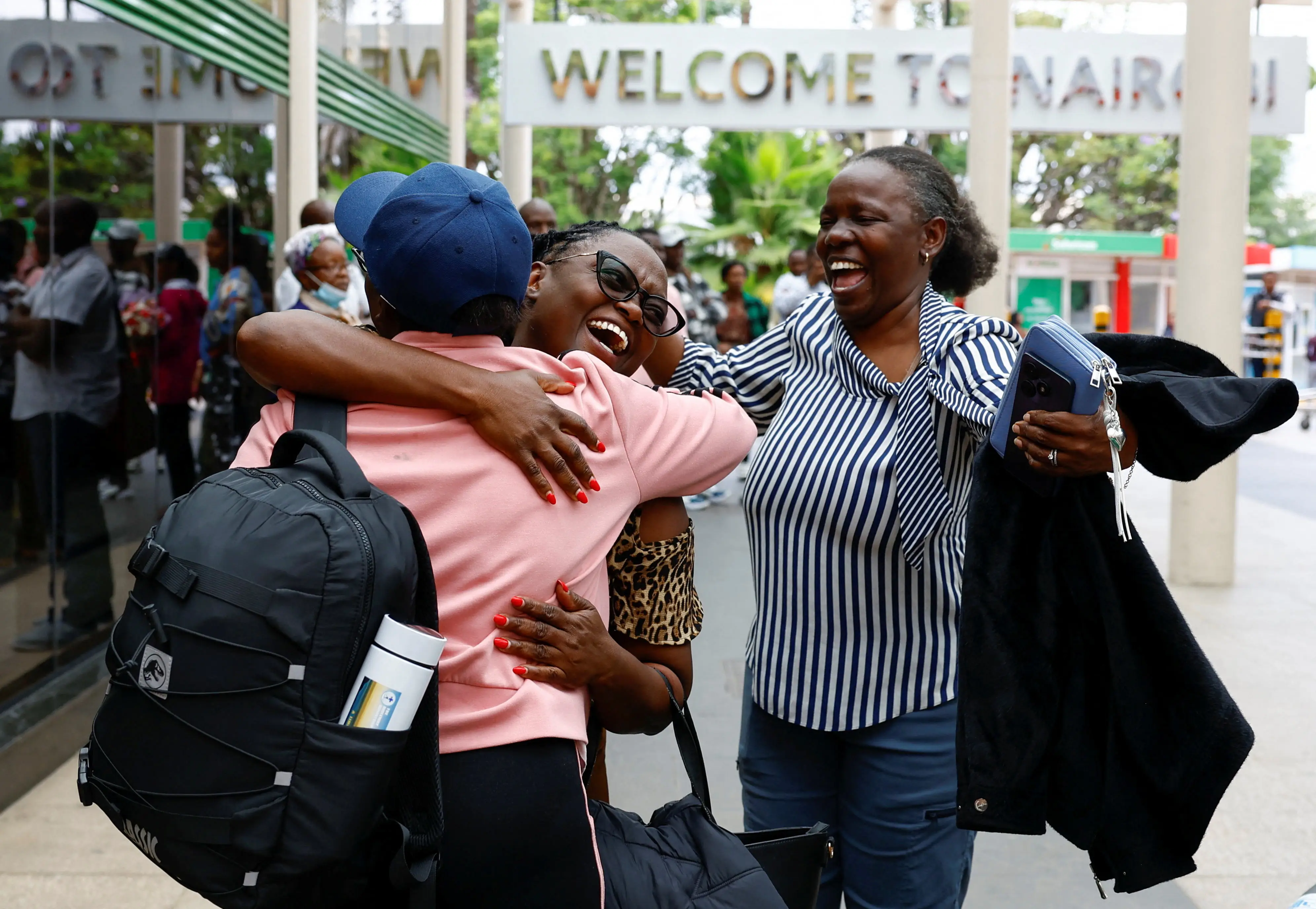 People hugging at an airport after being stuck in Dubai.