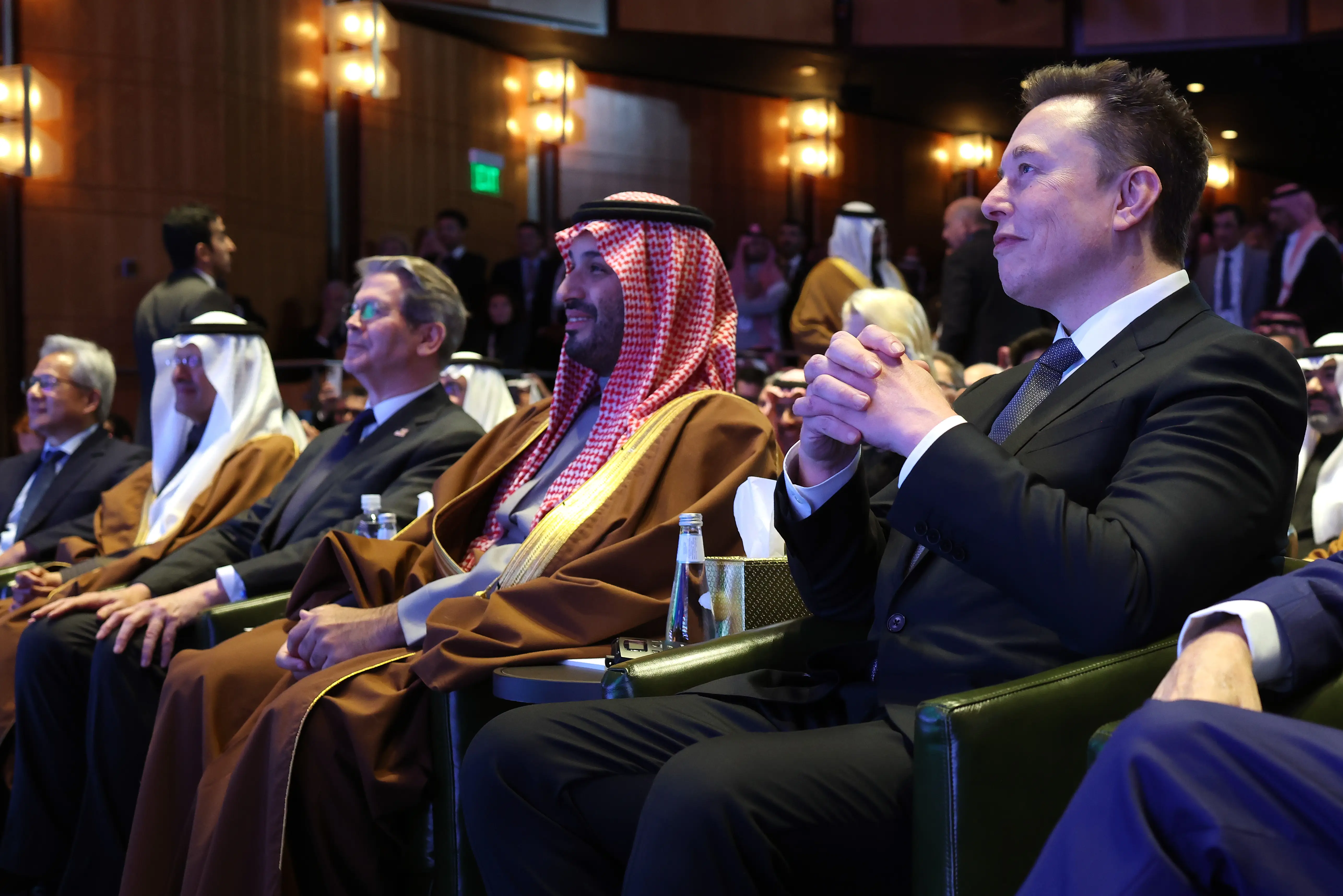 Crown Prince and Prime Minister Mohammed bin Salman of Saudi Arabia (middle) sits next to Elon Musk (right) and U.S. Treasury secretary Scott Bessent (left) at a U.S.-Saudi business conference in Washington, DC., November 2025.