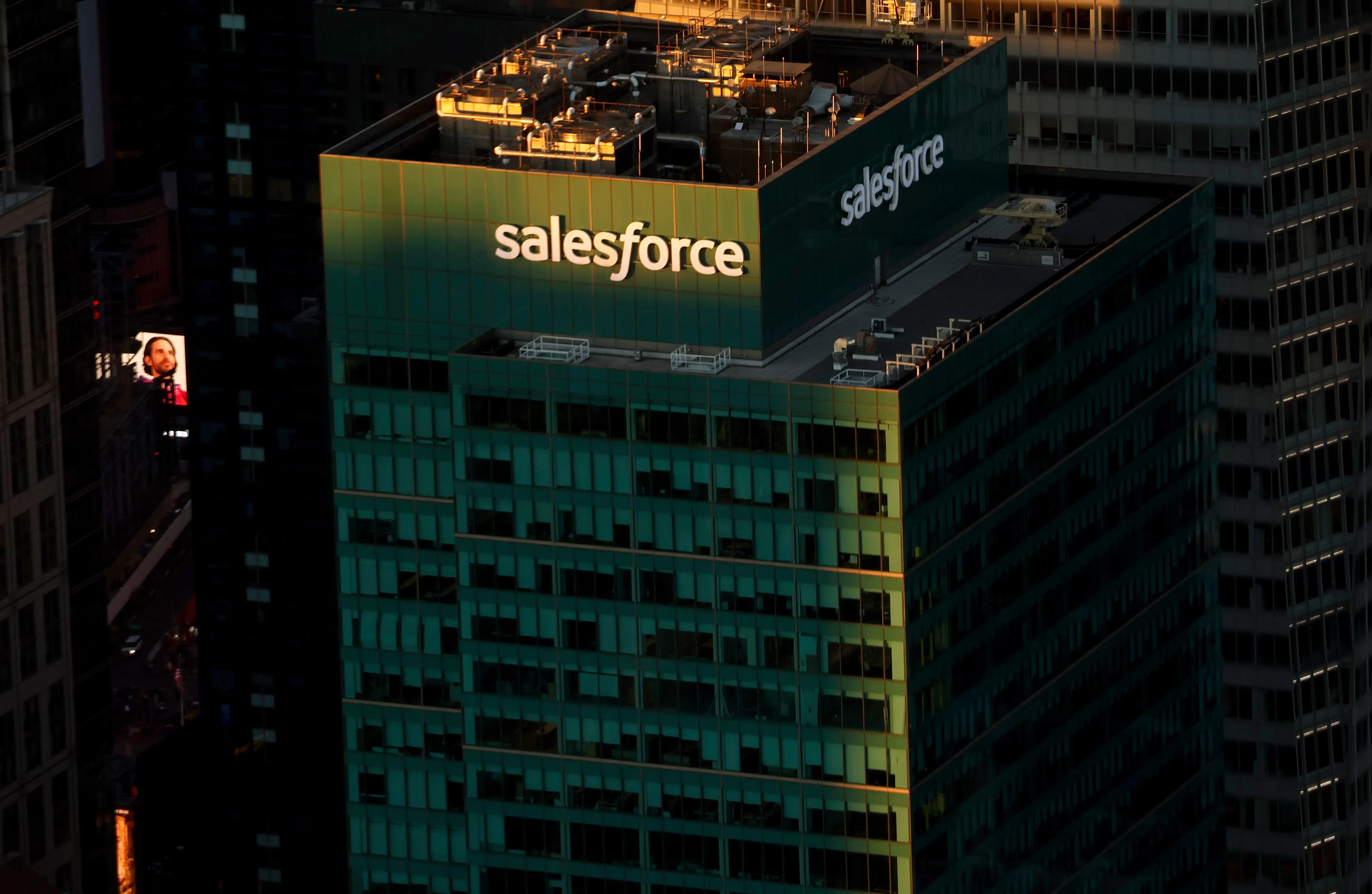 A Salesforce tower in New York City sits in the shadow of other tall office buildings.