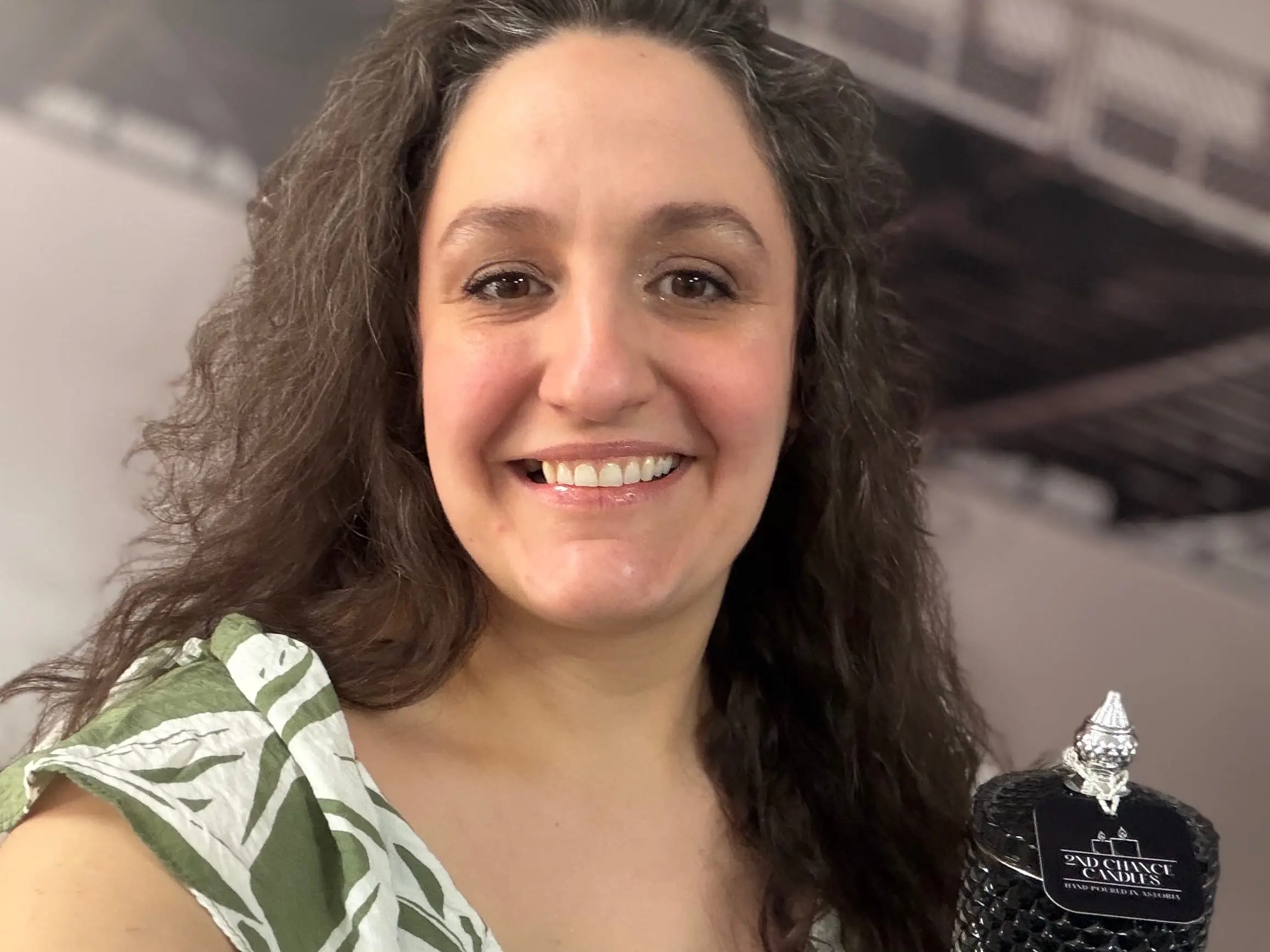 A woman holding a candle in a jar.