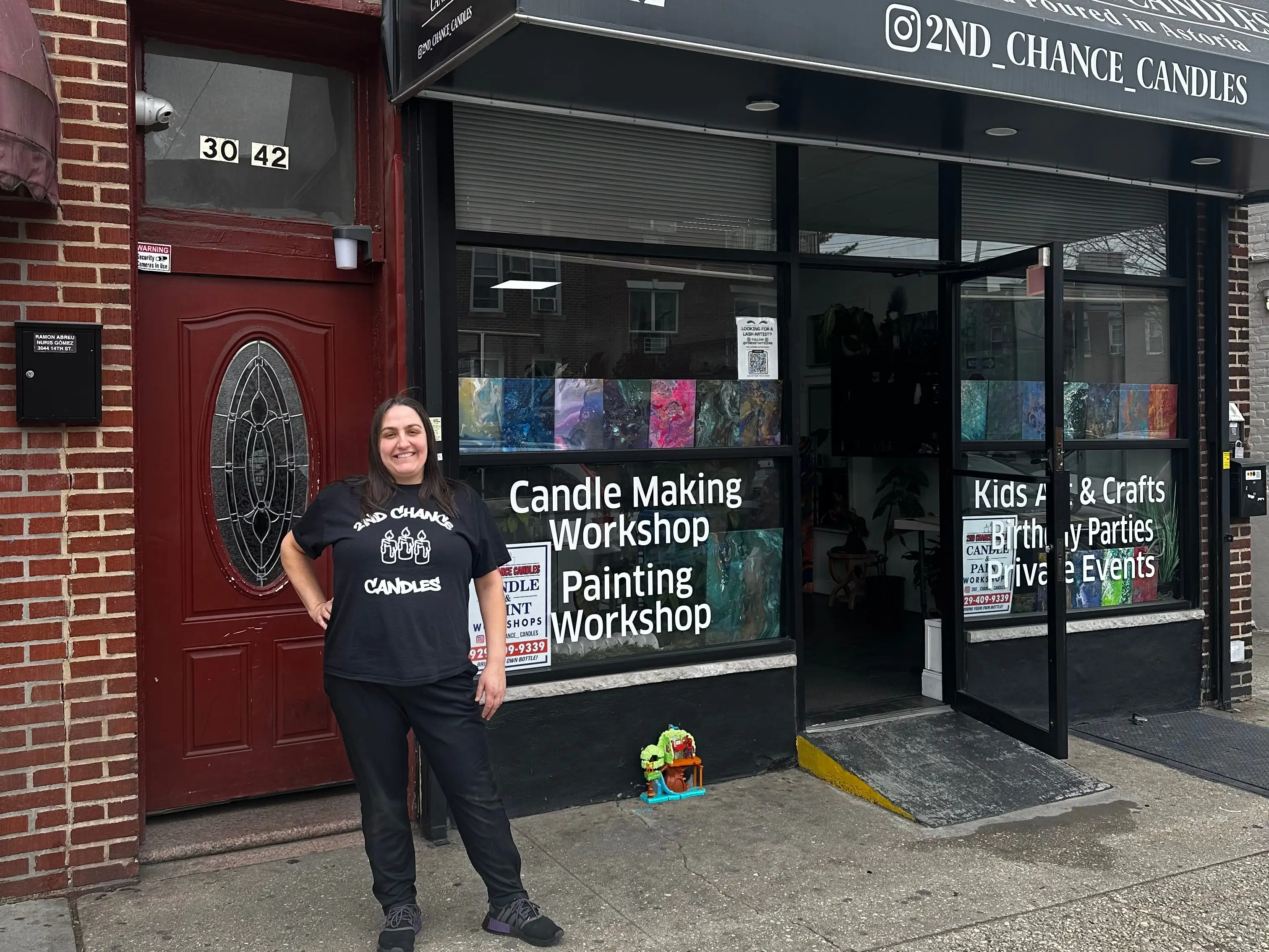 A woman outside a candle-making store.