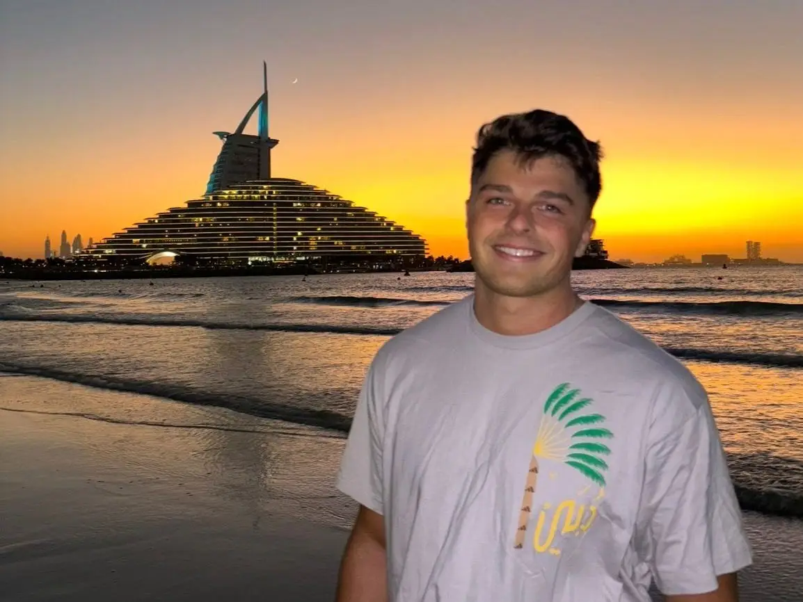 Charlie Lovett on the beach in Dubai at sunset.