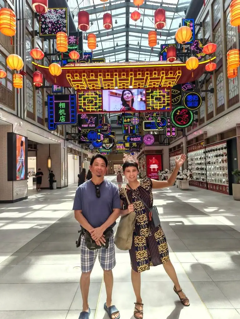 Fate Show and her father standing in the Dubai Mall China Town with lanterns hanging behind them.