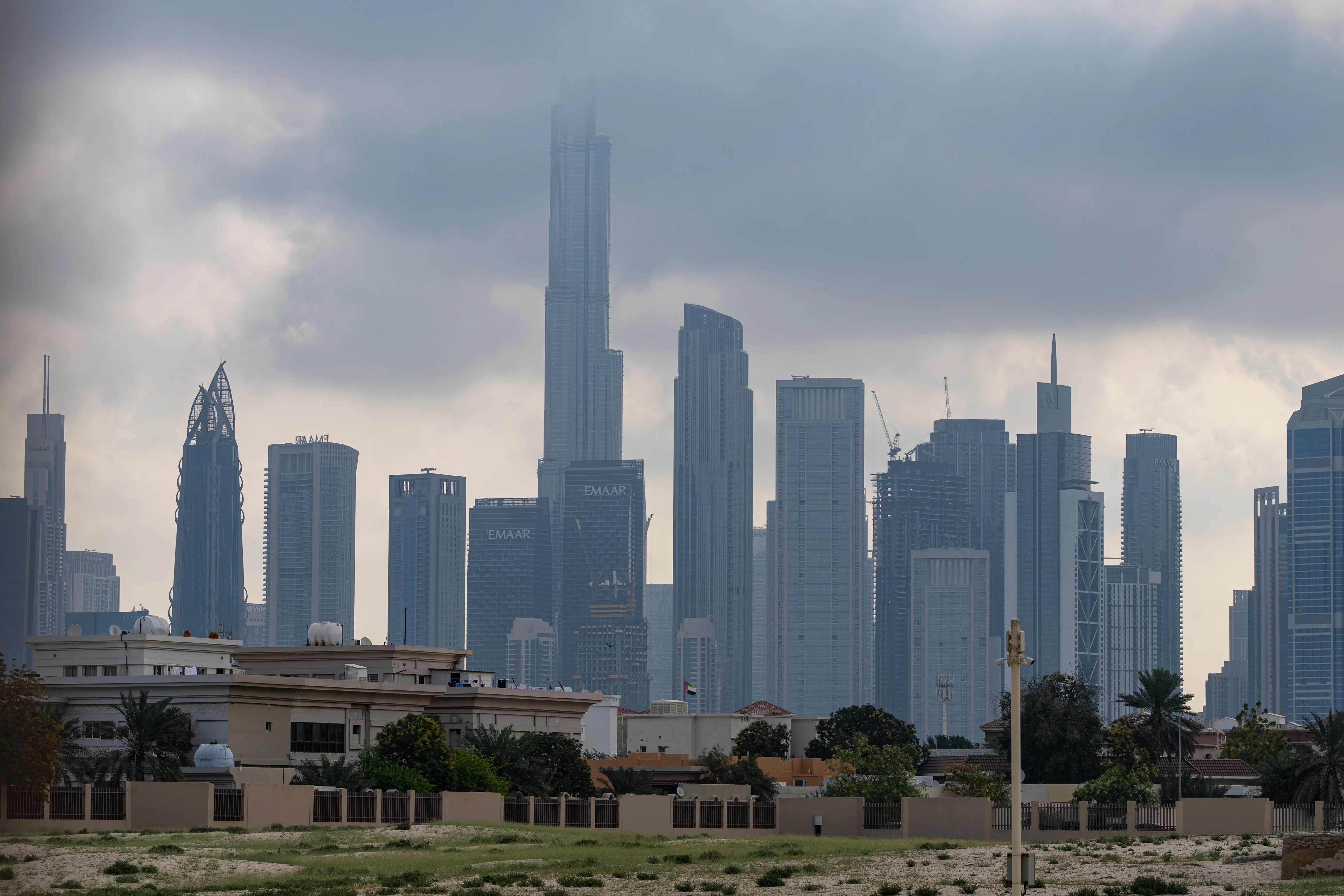 Burj Khalifa skyline in Dubai obstructed by clouds.