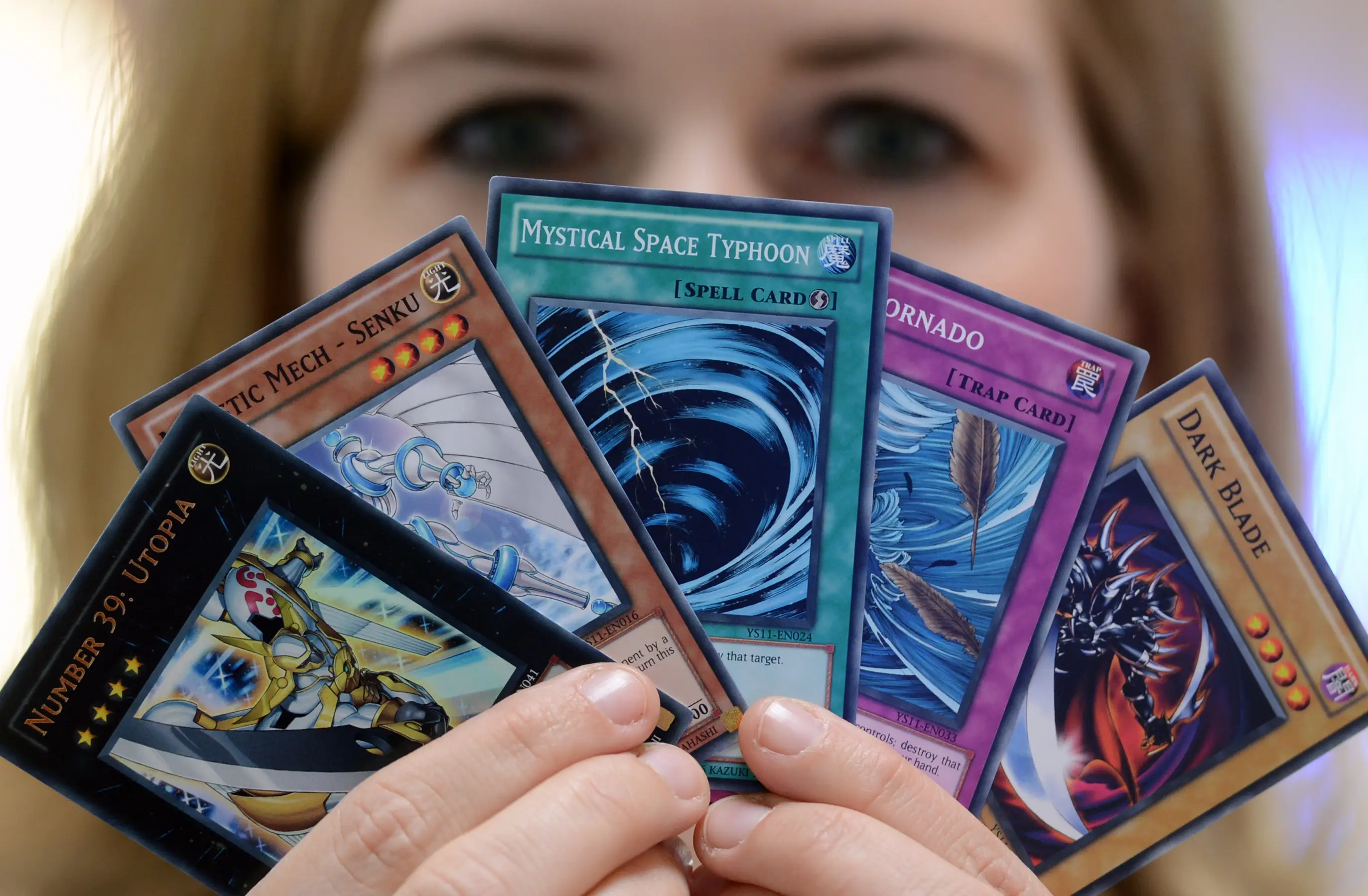 Woman holding Yu-Gi-Oh! cards