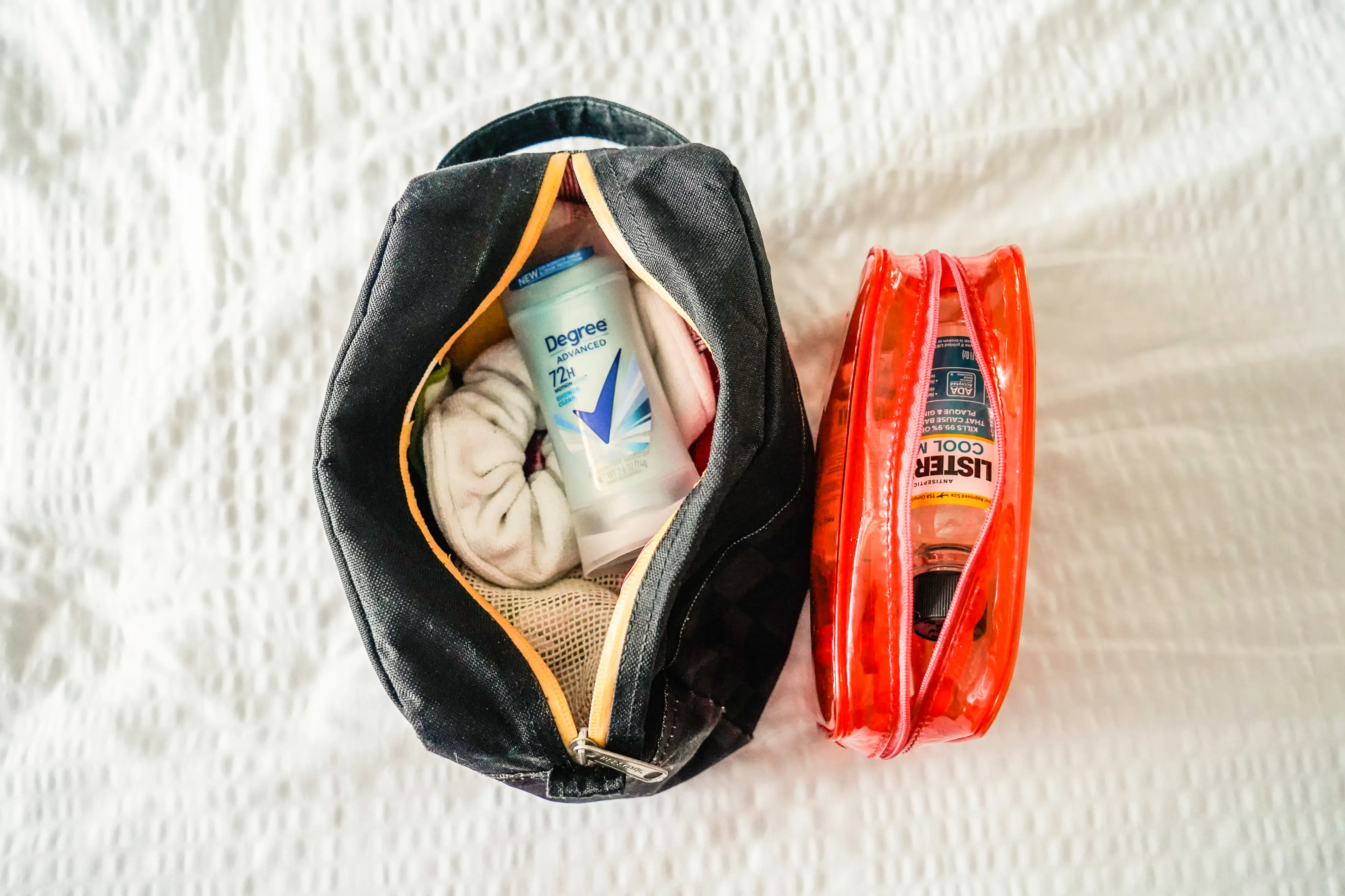 The author's packed toiletries on a white sheet
