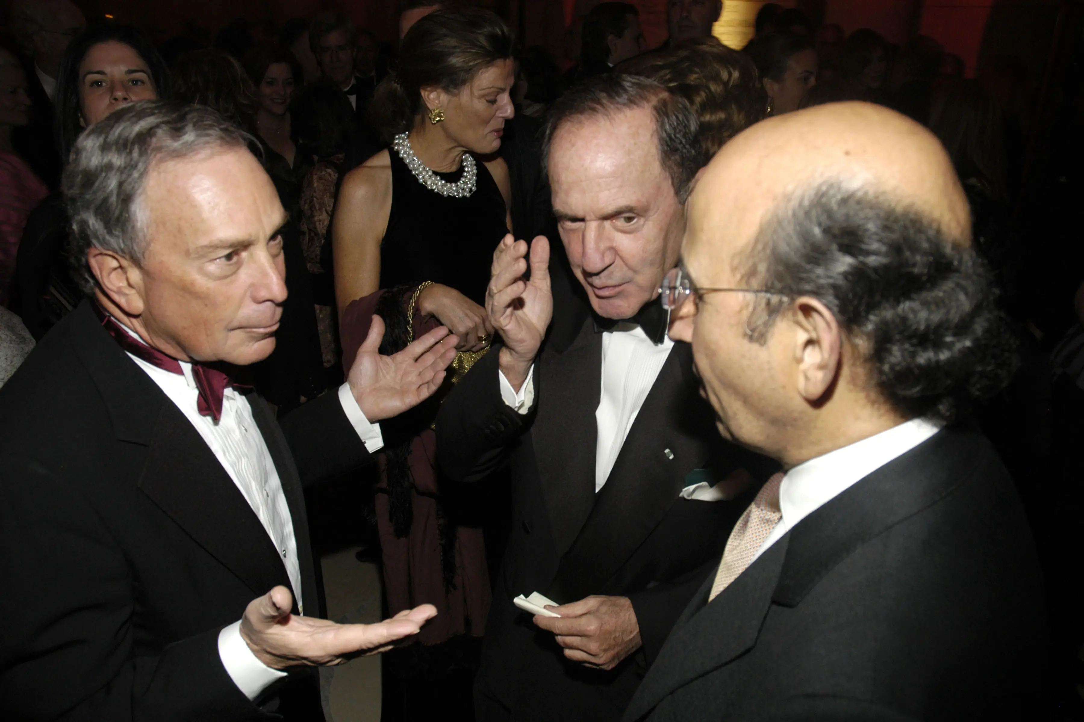 Three men in suits and tuxedos