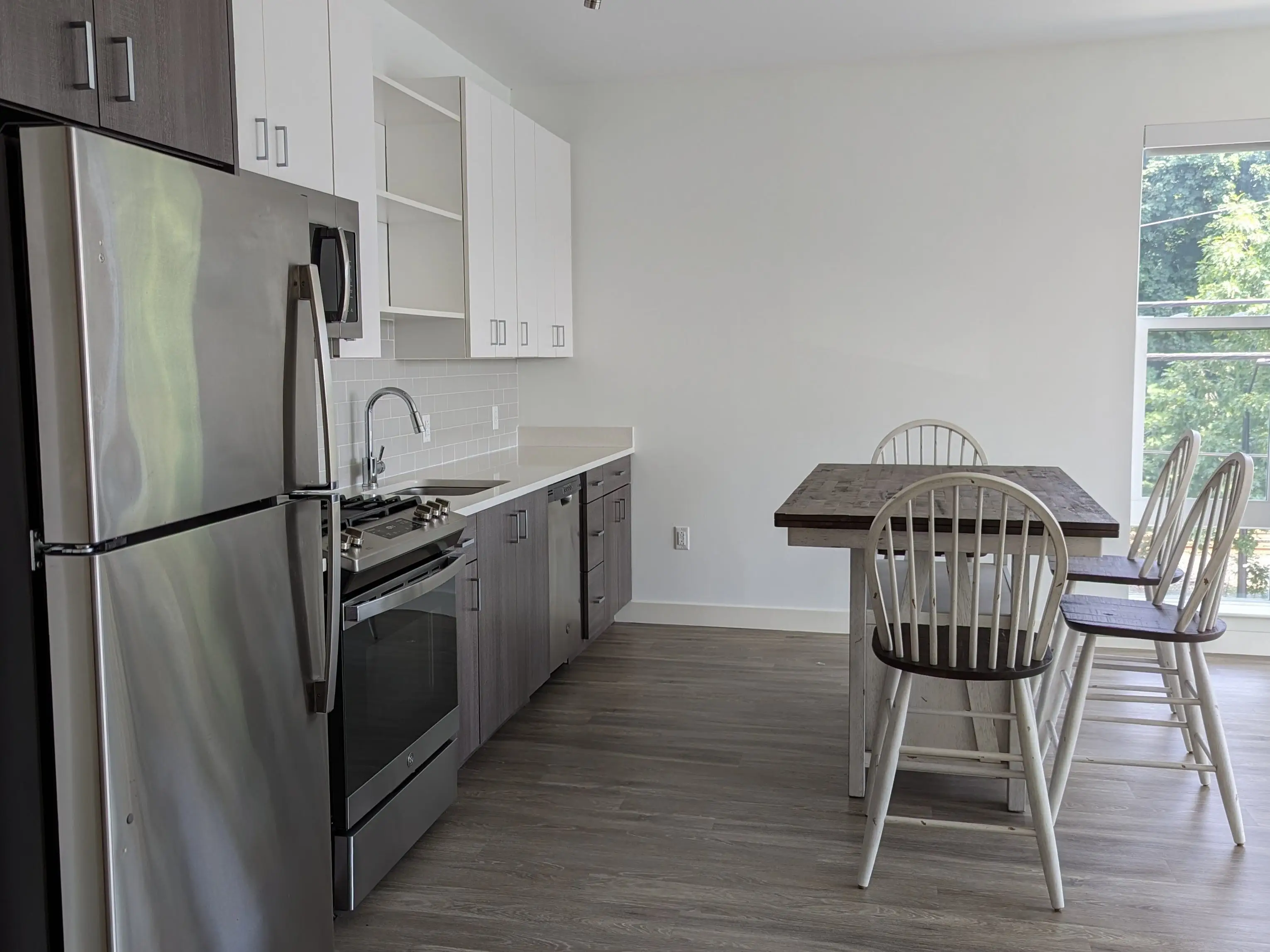 A kitchen with a small table.