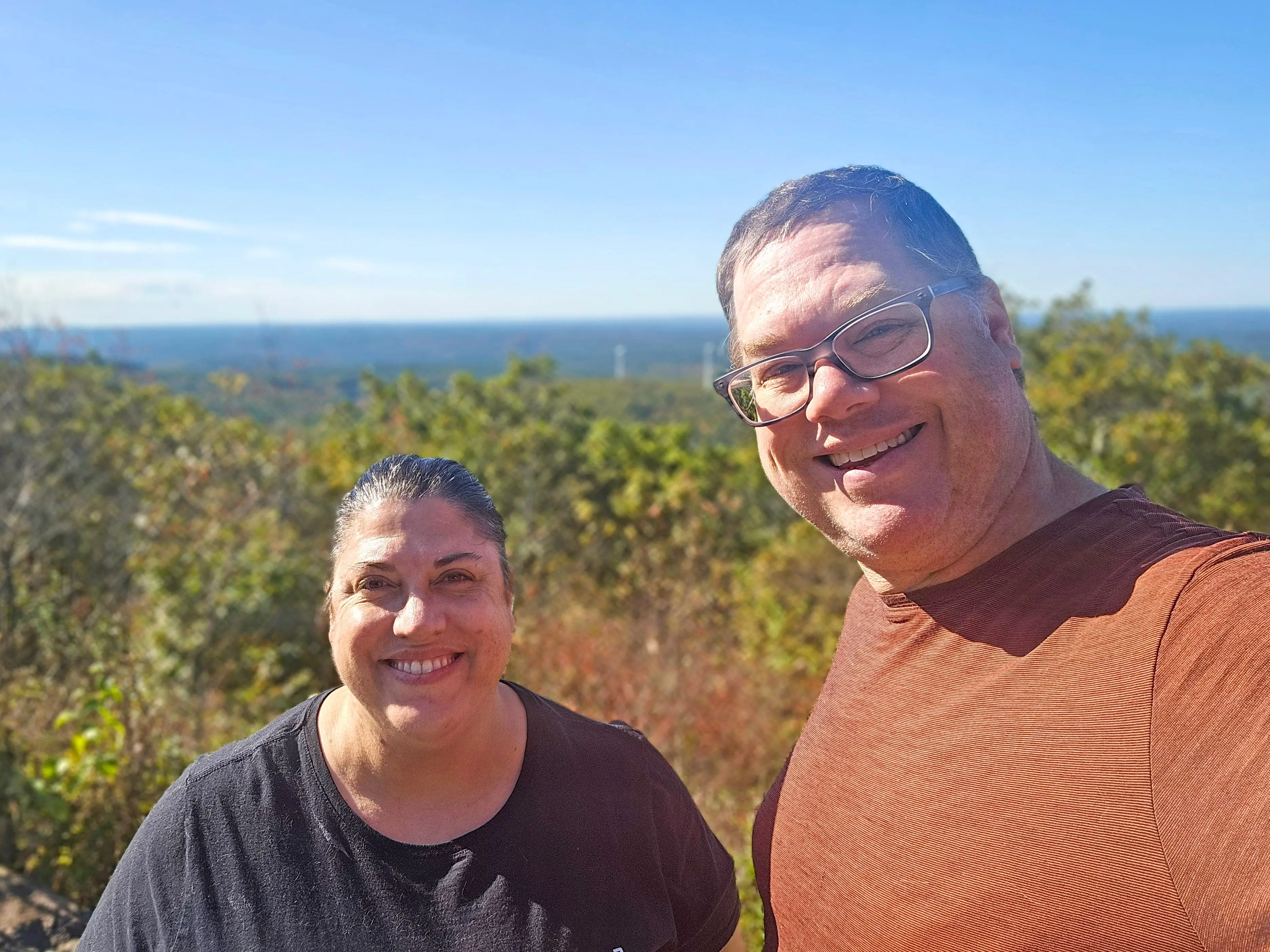 Julia and her husband pose while on a hike.