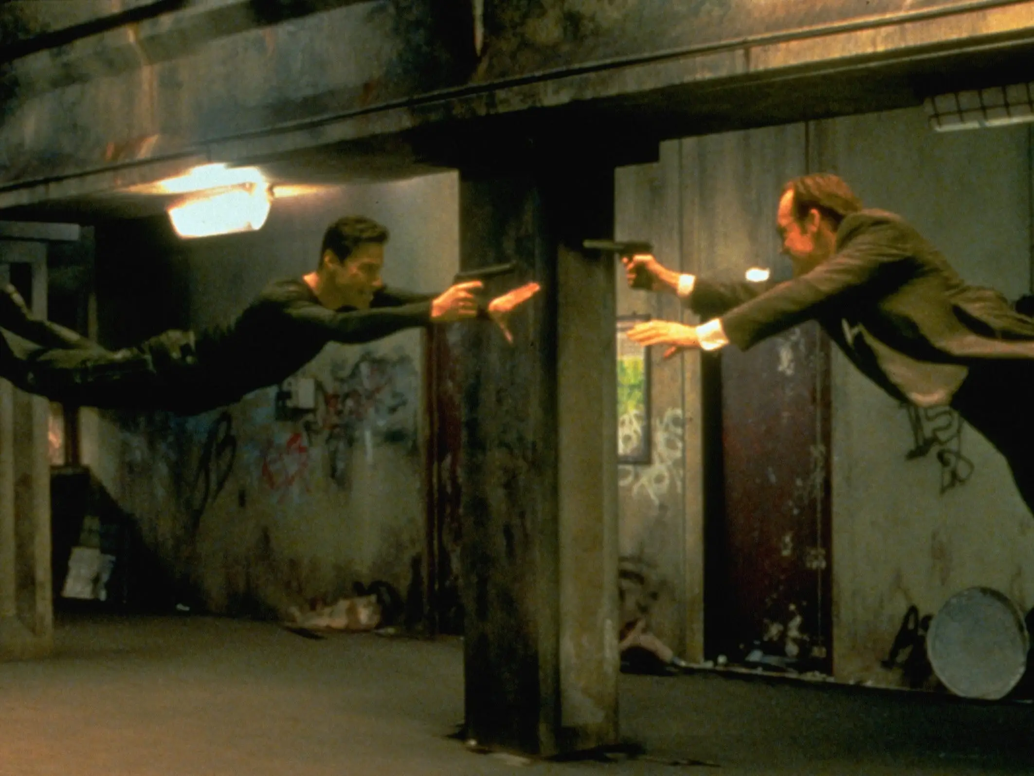 Keanu Reeves and Hugo Weaving face each other in a scene from Andy and Larry Wachowski's 1999 movie The Matrix.