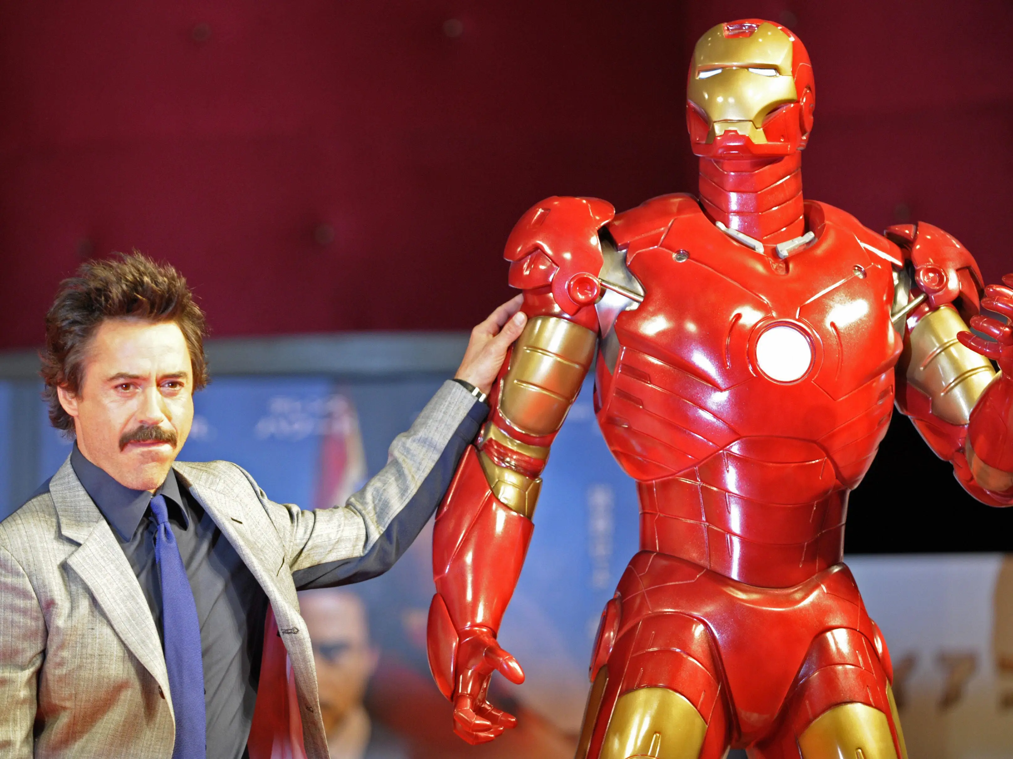 US actor Robert Downey Jr. poses by a life-size Iron Man model during a press conference on his latest movie Iron Man, in Tokyo, on September 3, 2008