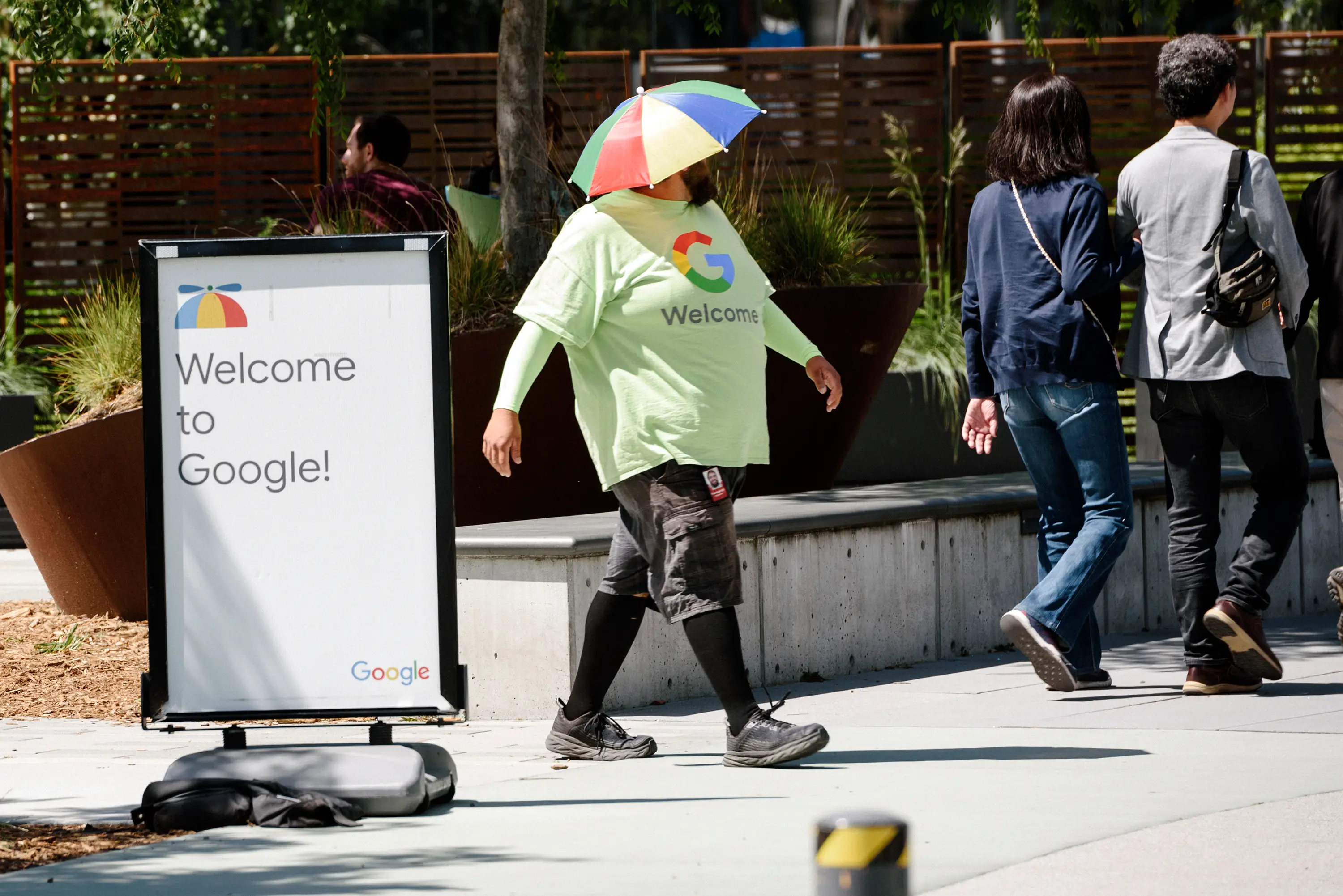A person wearing an umbrella hat at a Google welcome event