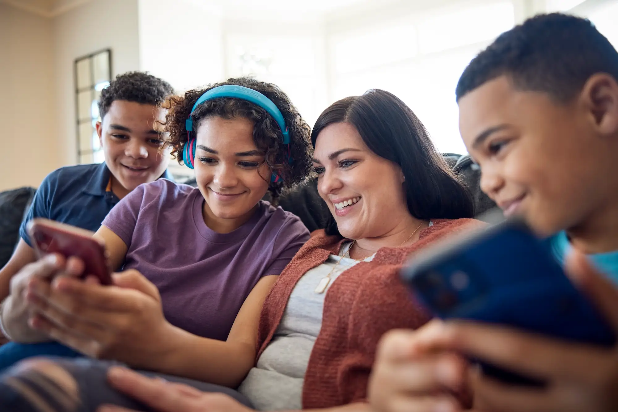 A group of kids and an older adult using a smartphone