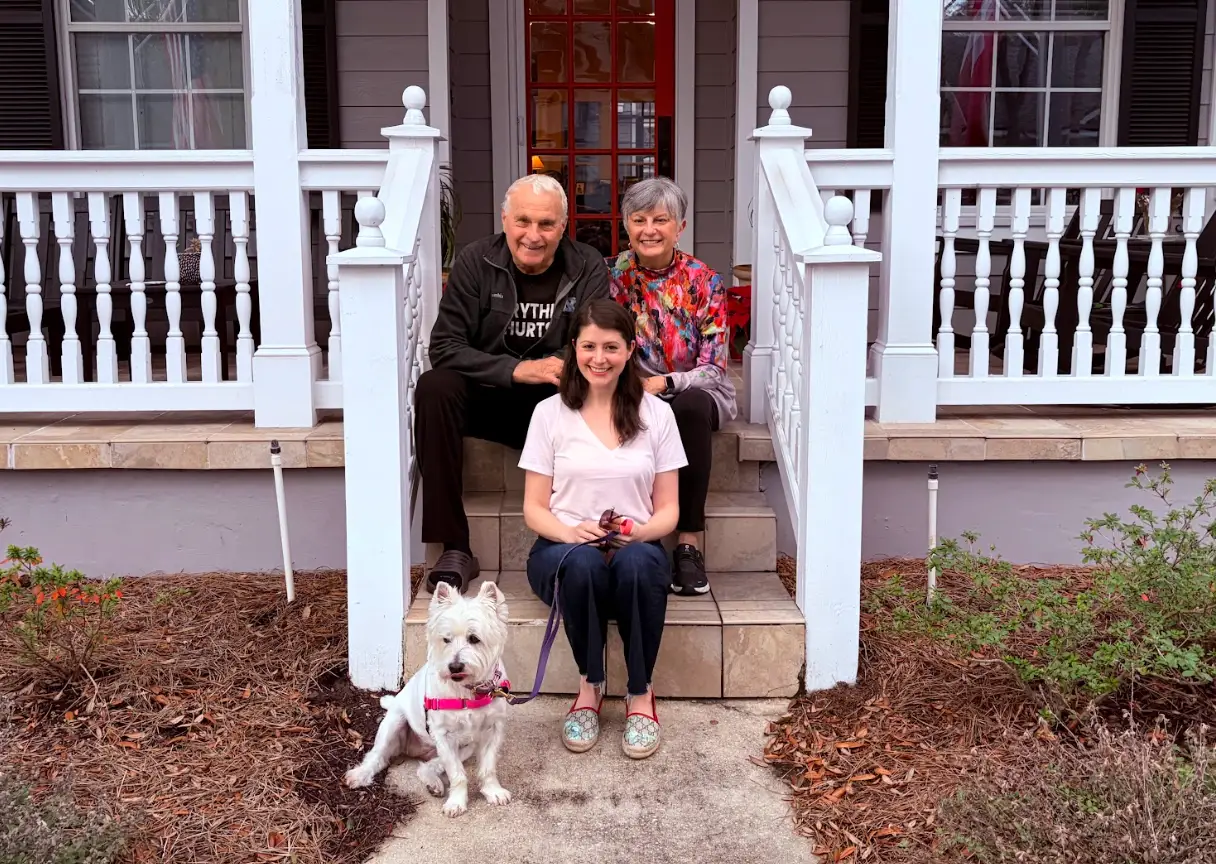 The writer sitting on a stoop with her dog