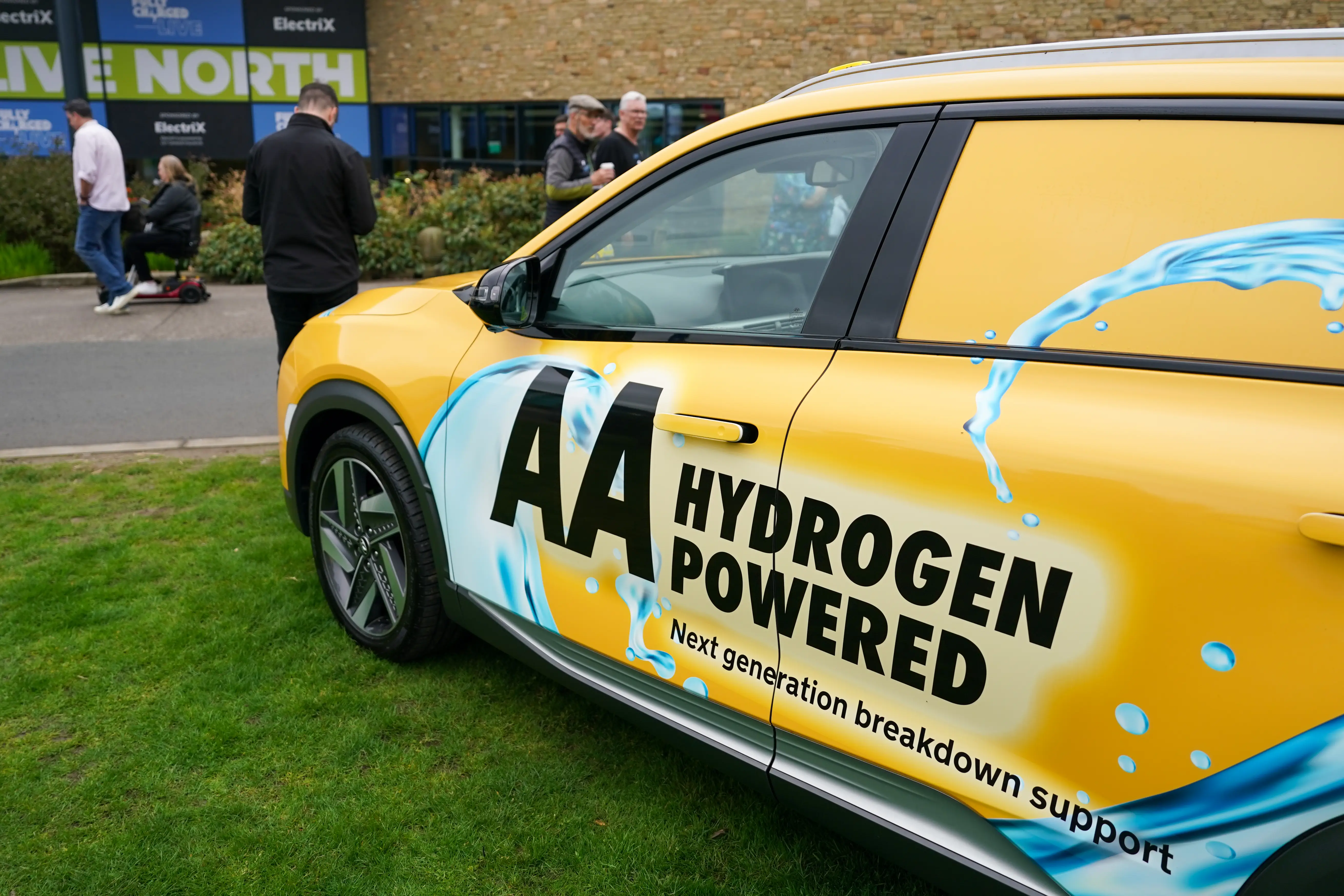 A hydrogen powered commercial vehicle used by the AA is parked on grass while on display at a Fully Charged live show.