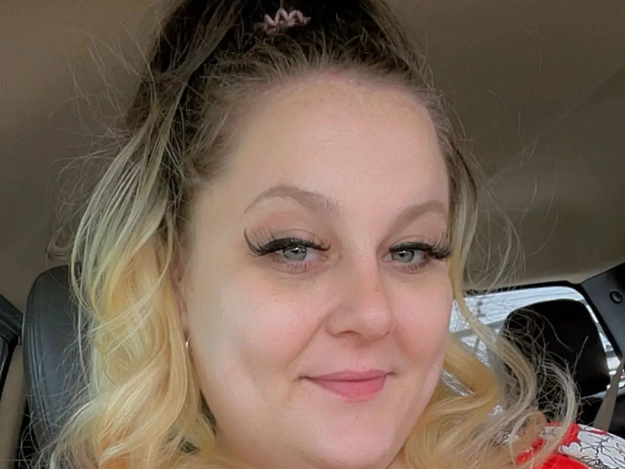 A woman wearing a flower-pattern red top.