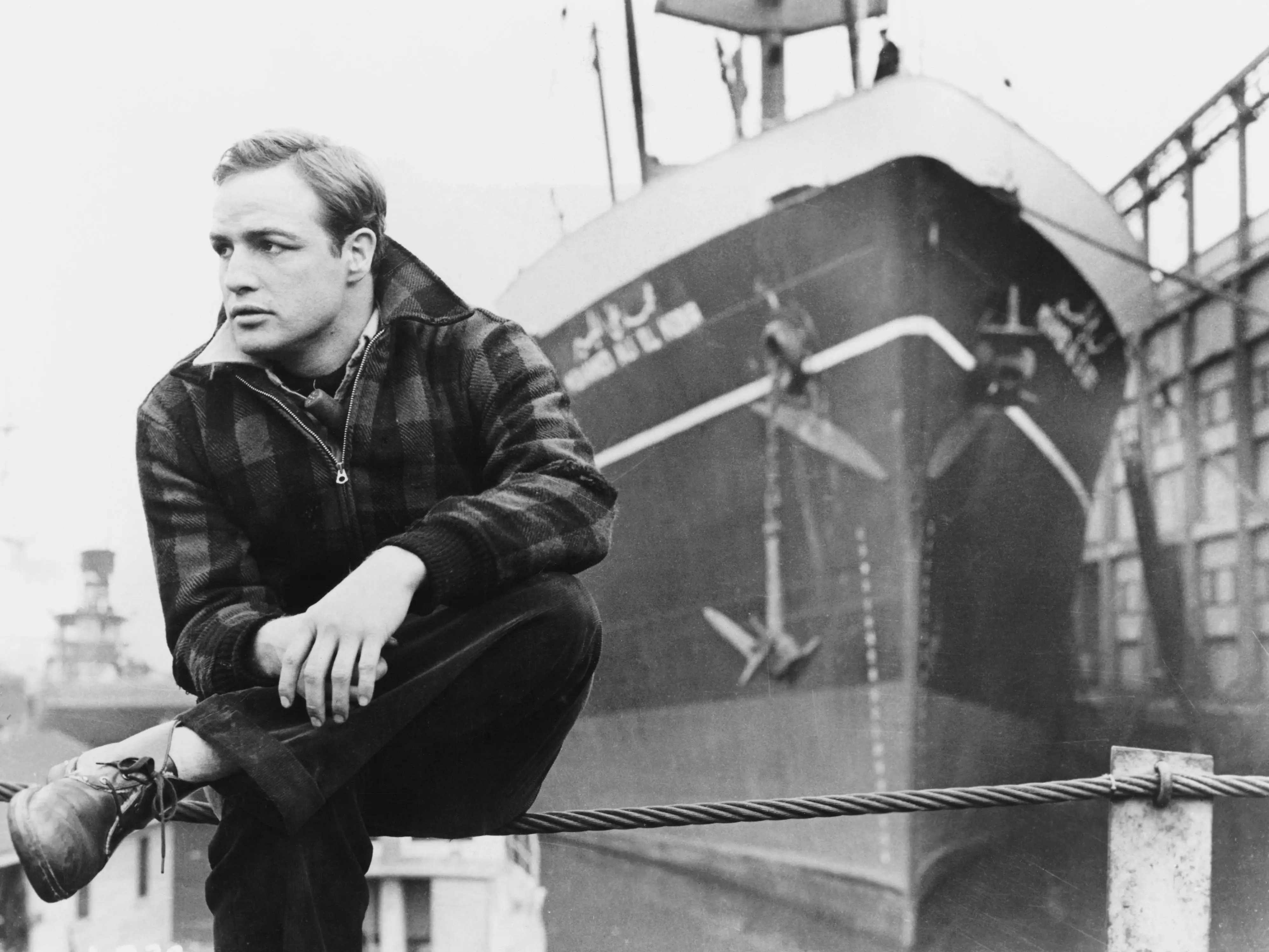 Marlon Brando sitting on a dock in 