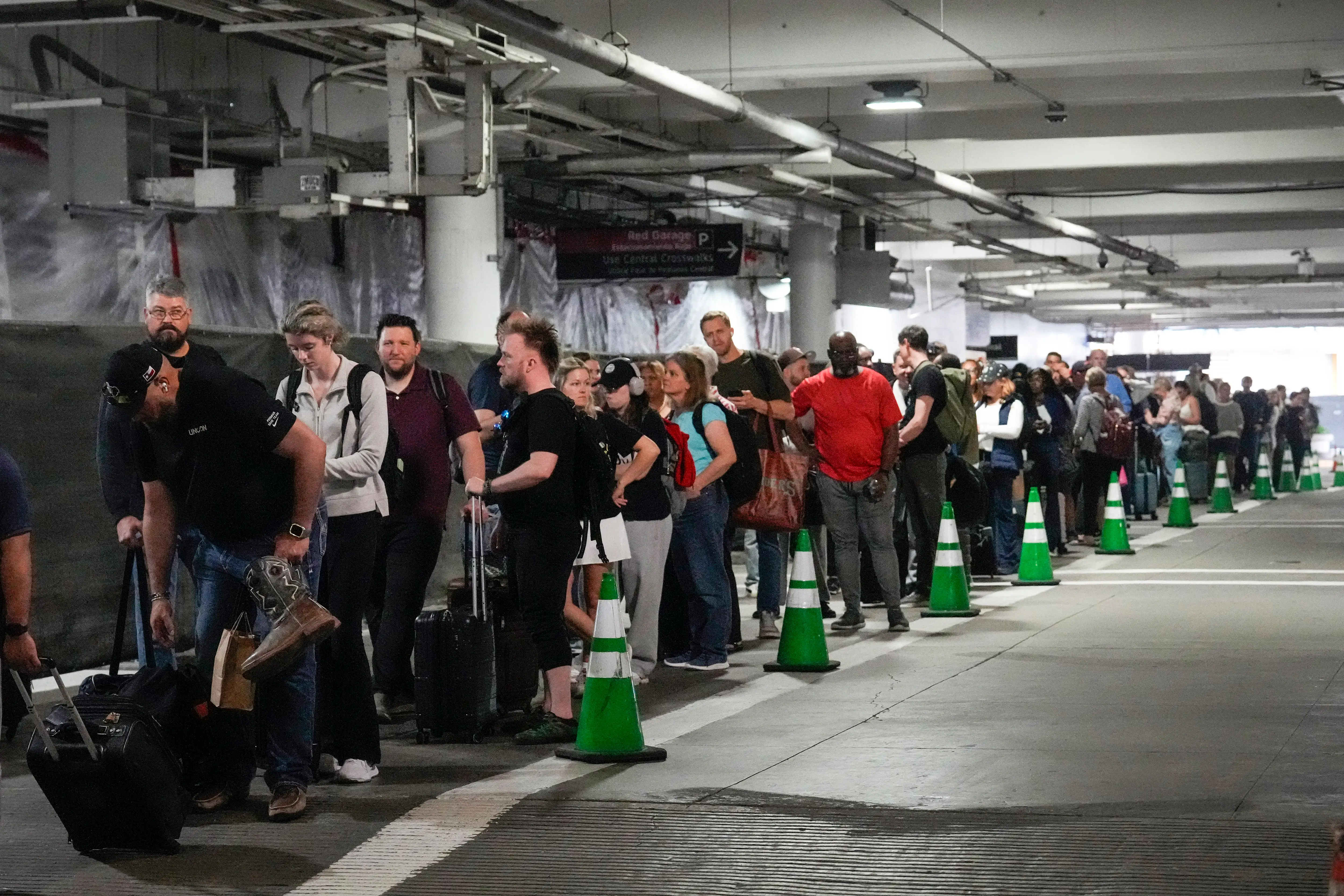 Passengers in parking garage where TSA line is.