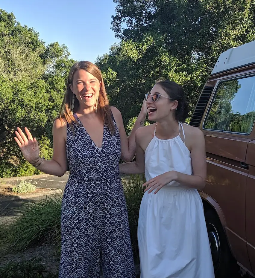 Two women standing in sunshine