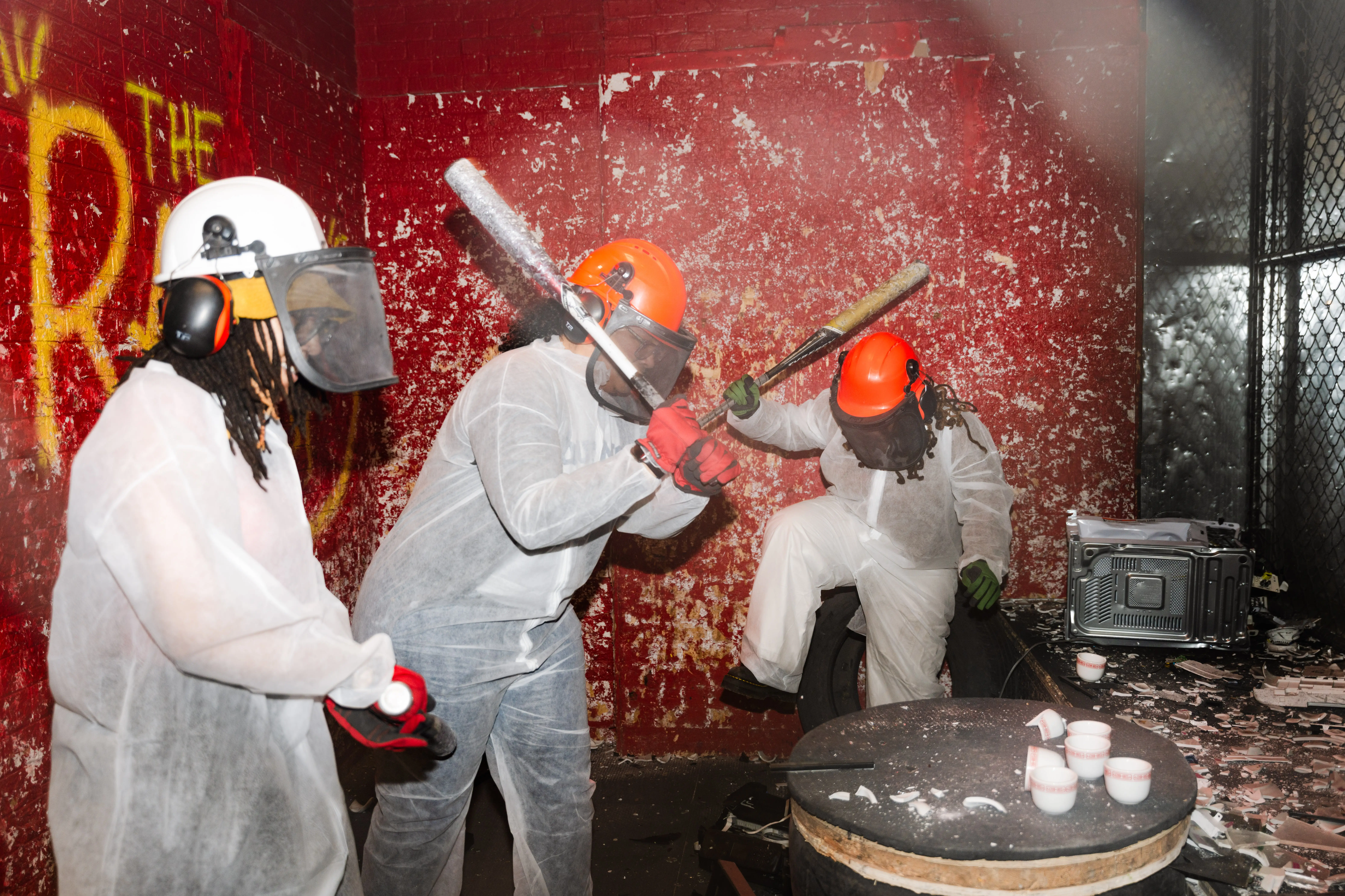 A group of colleagues from a school in the Bronx smashes teacups, printers and other electronics in a 