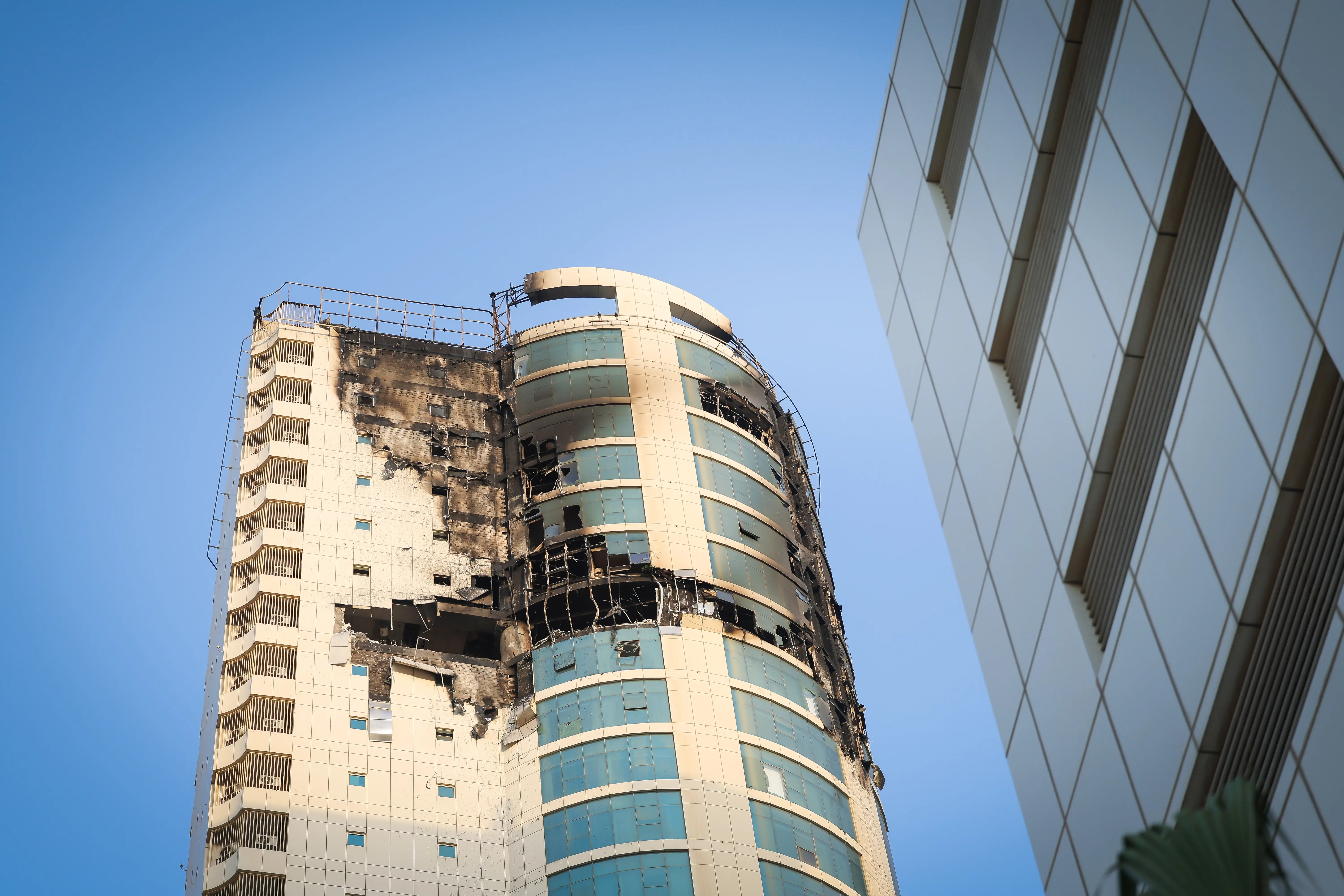 An apartment building in Bahrain lies damaged from an Iraniand rone.