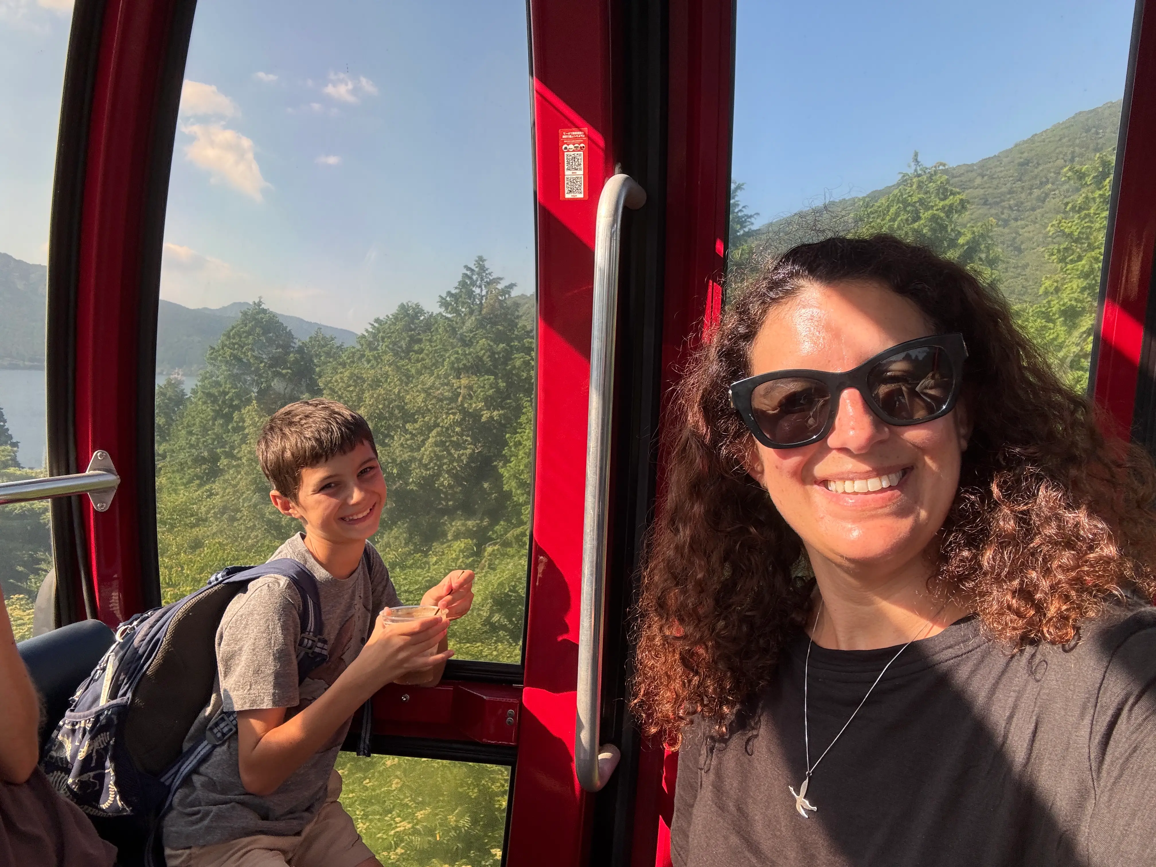 Author Jamie Davis Smith and son smiling next to red door with windows