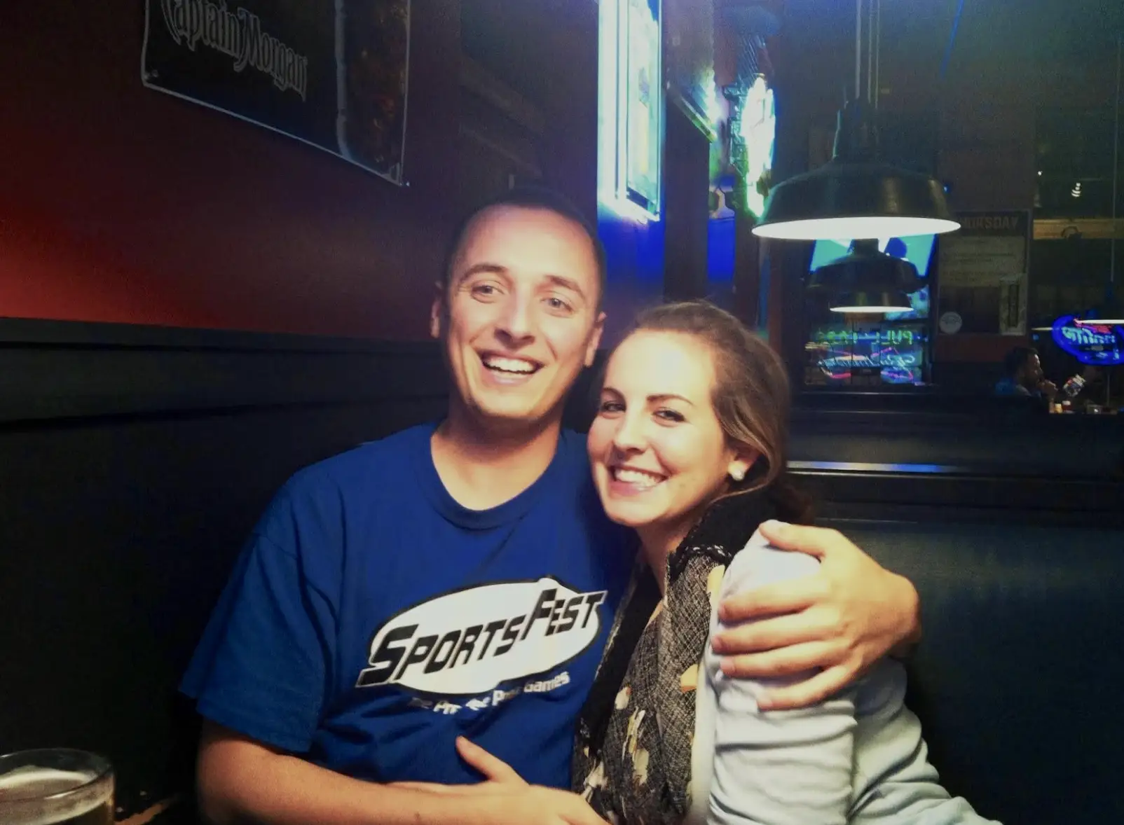 The writer and her husband sitting in the booth at a bar.