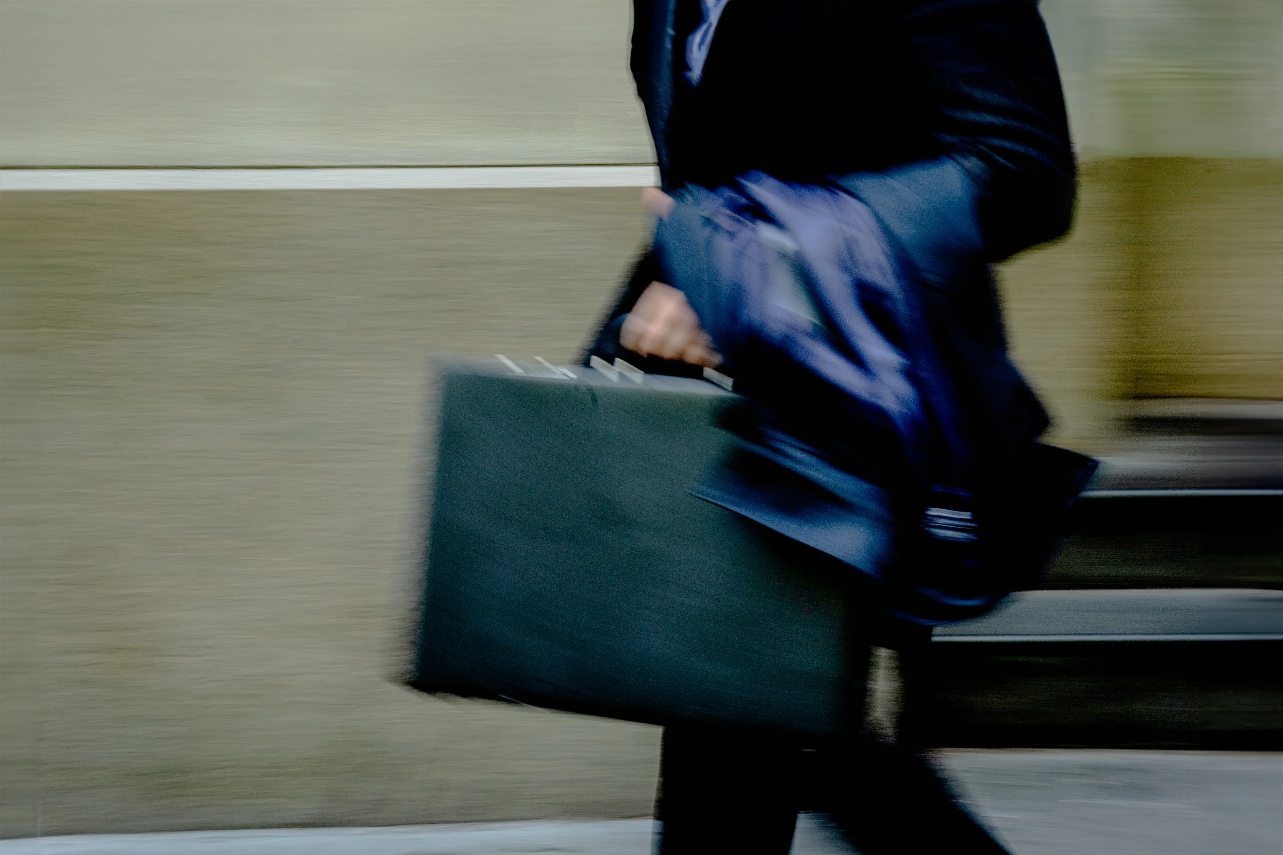 A man in motion, carring a briefcase