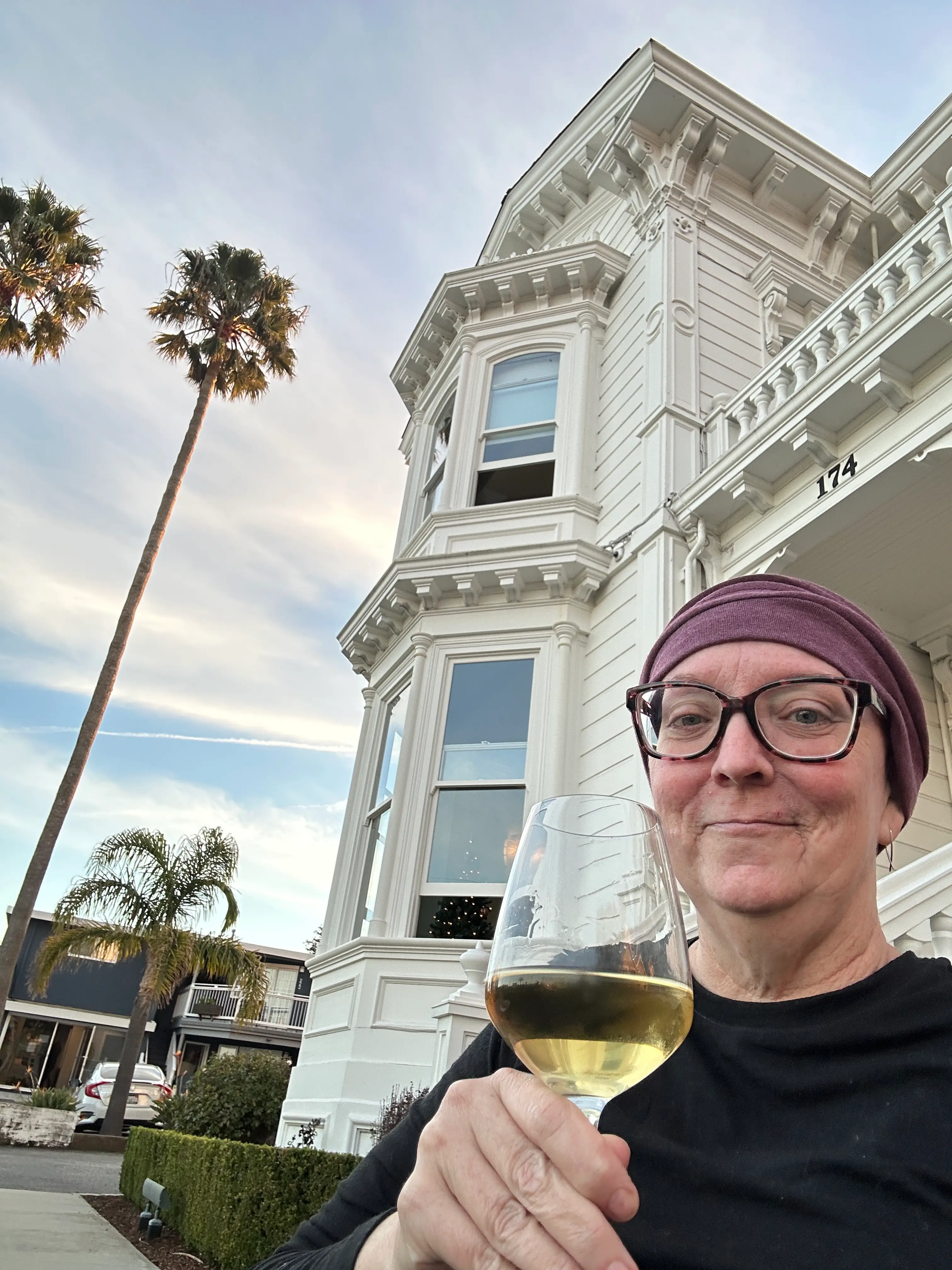 The author poses with a glass of wine while outside in Santa Cruz.