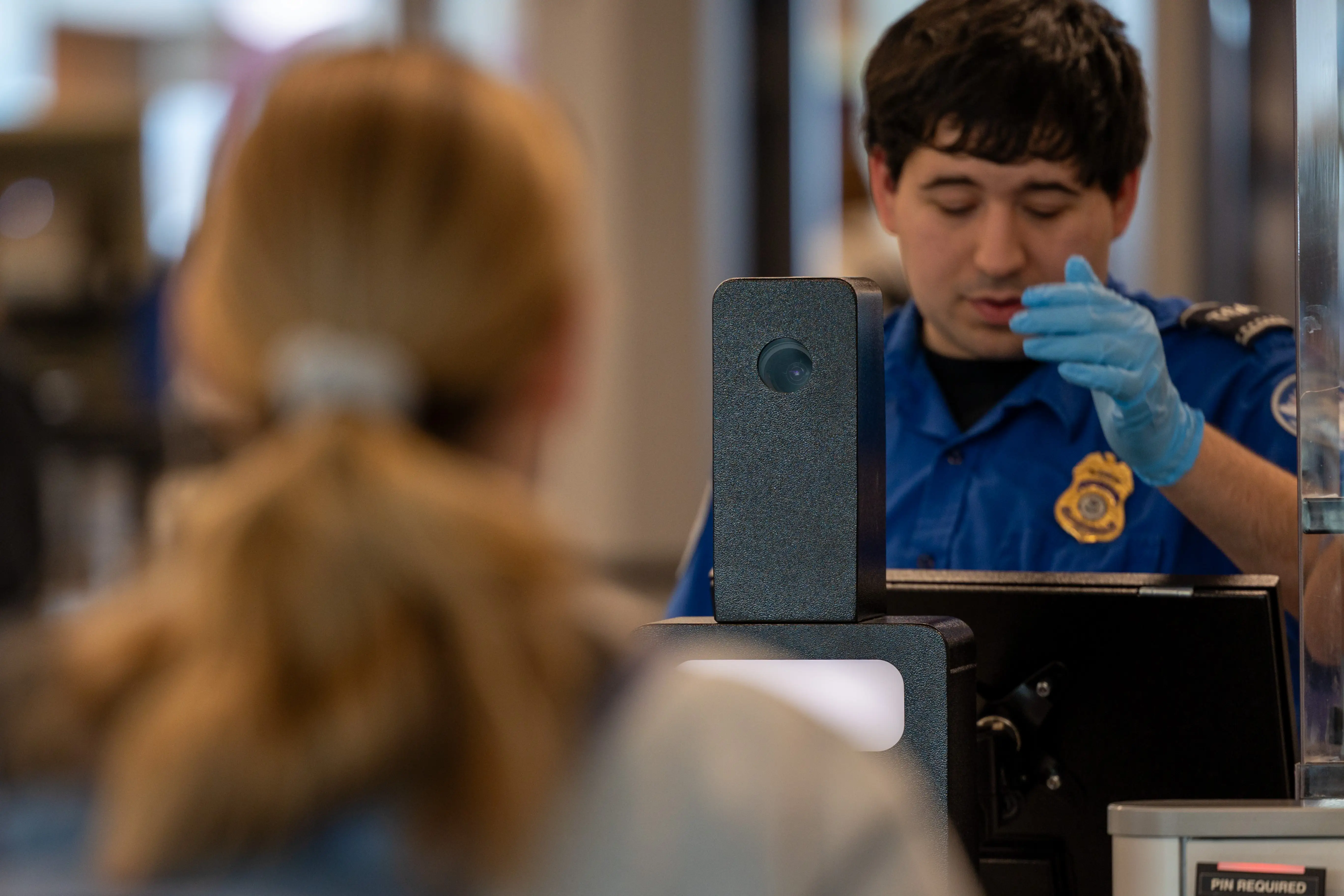 TSA agent at Touchless ID stand in Charlotte.