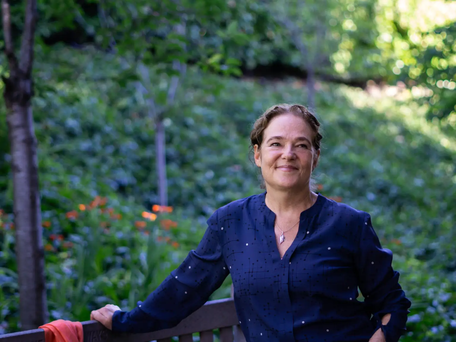 Samantha Miller in front of greenery