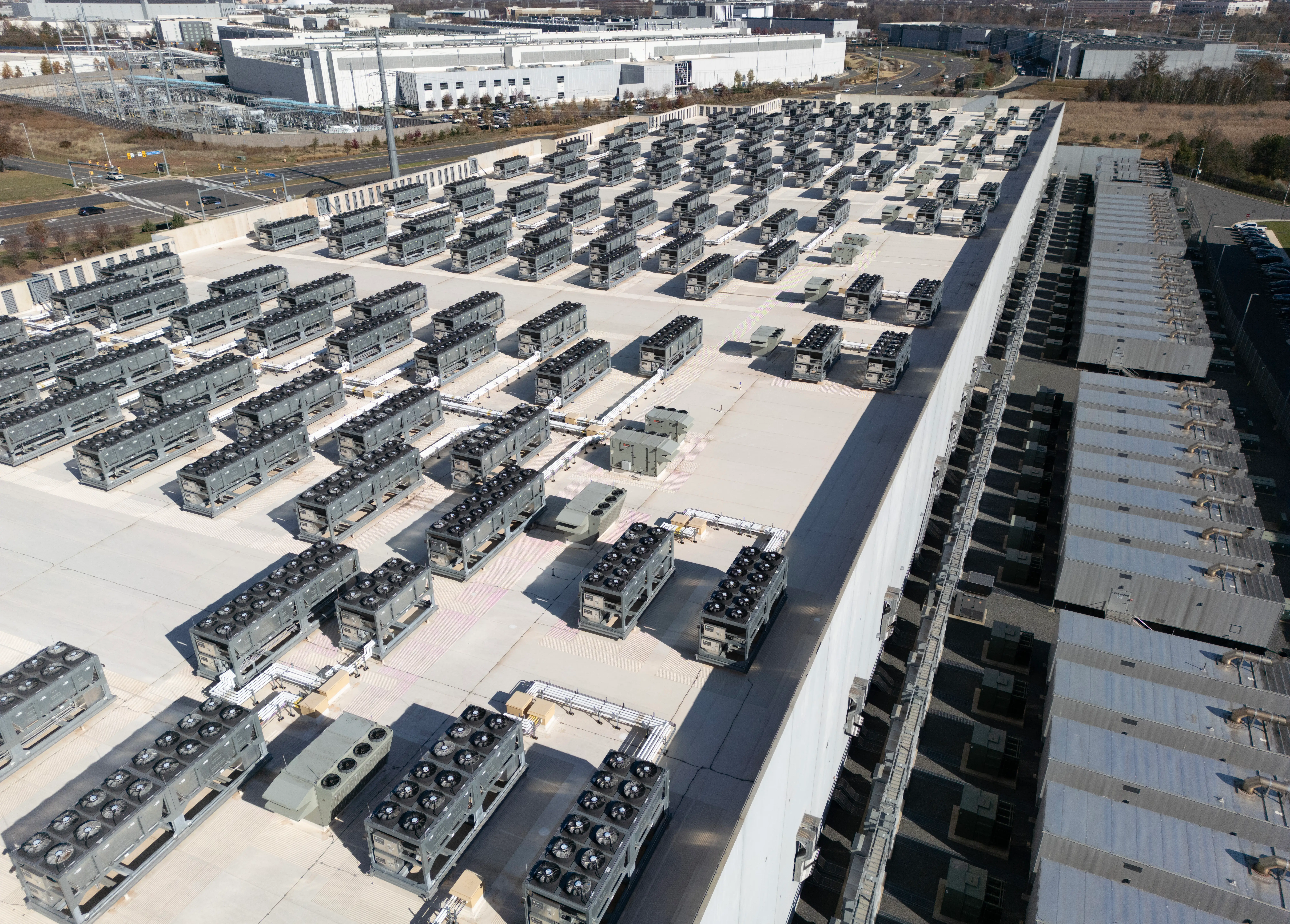 An aerial view shows cooling vent fans on the roof next to generators on the lower level of a Digital Realty data center in Ashburn, Virginia.