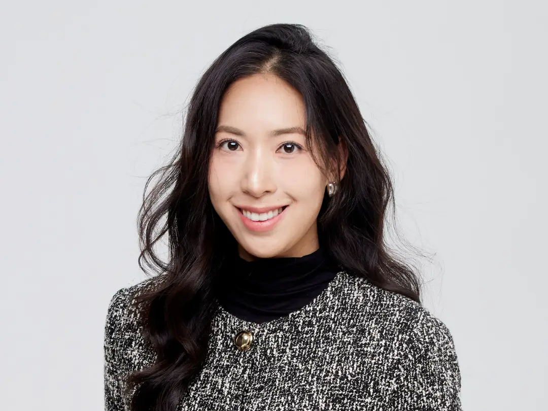 headshot of a woman on a gray background