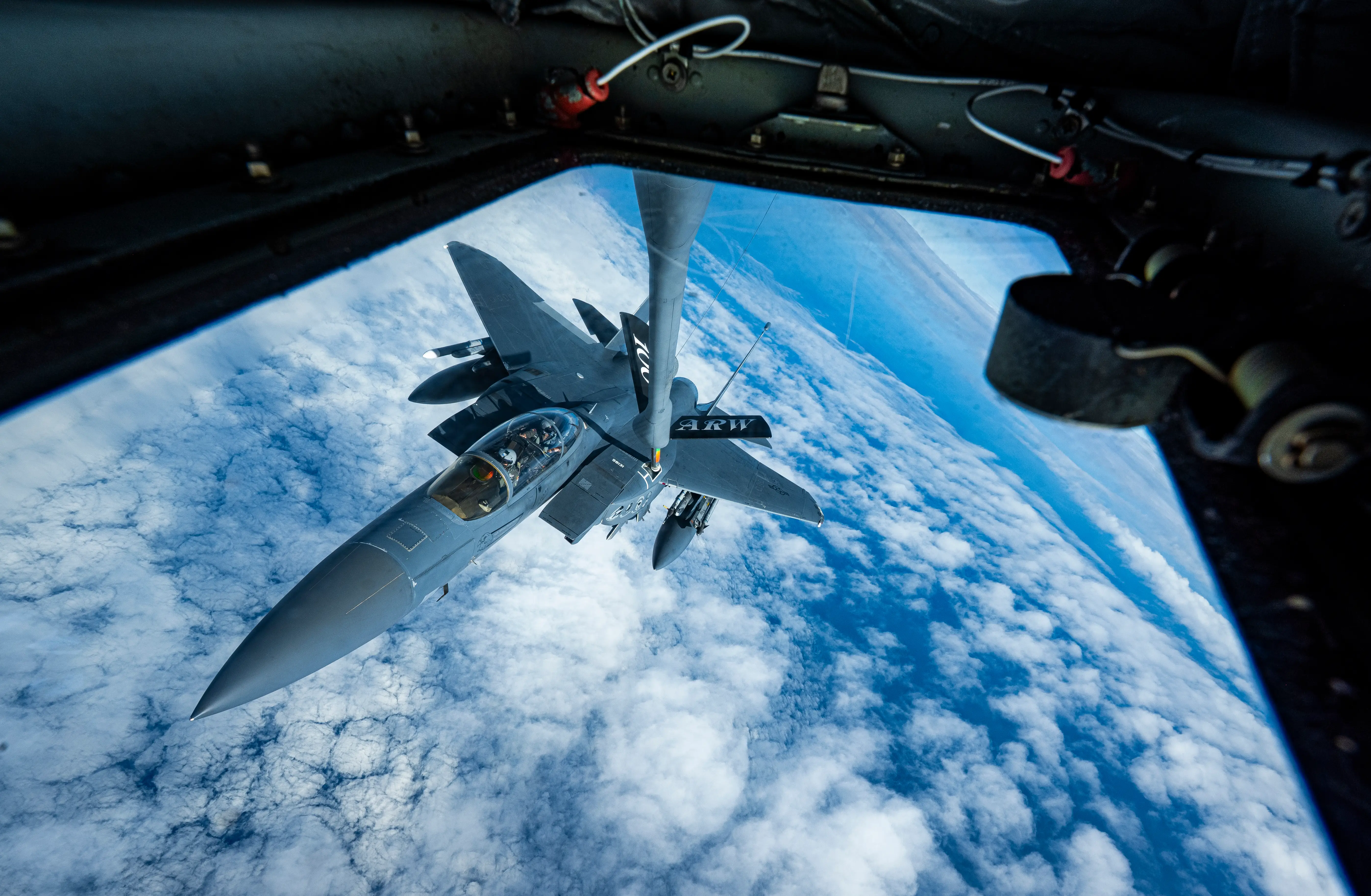 An F-15E Strike Eagle receives in-flight refueling from a KC-135 Stratotanker.