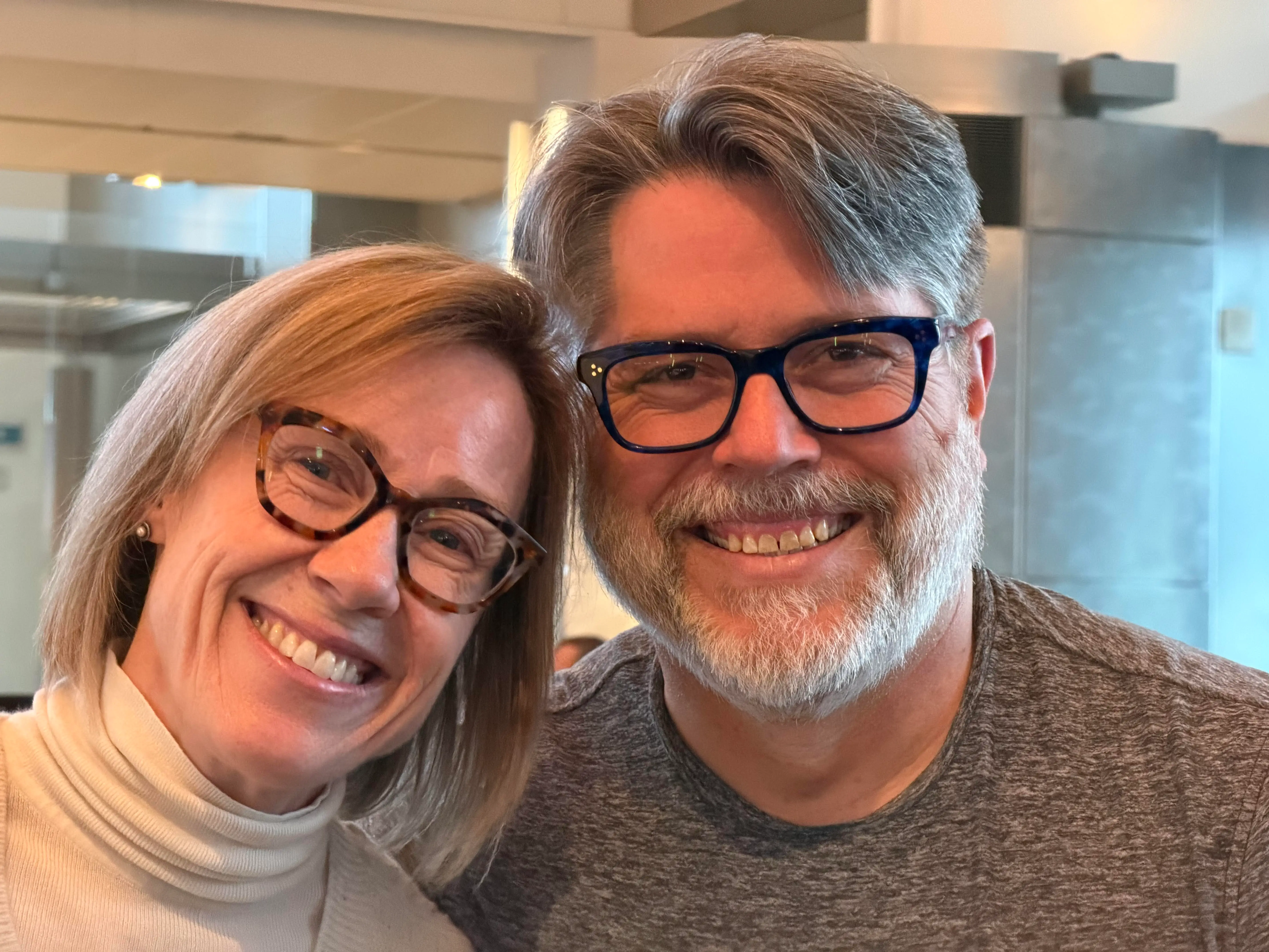 A couple smiles in a selfie.