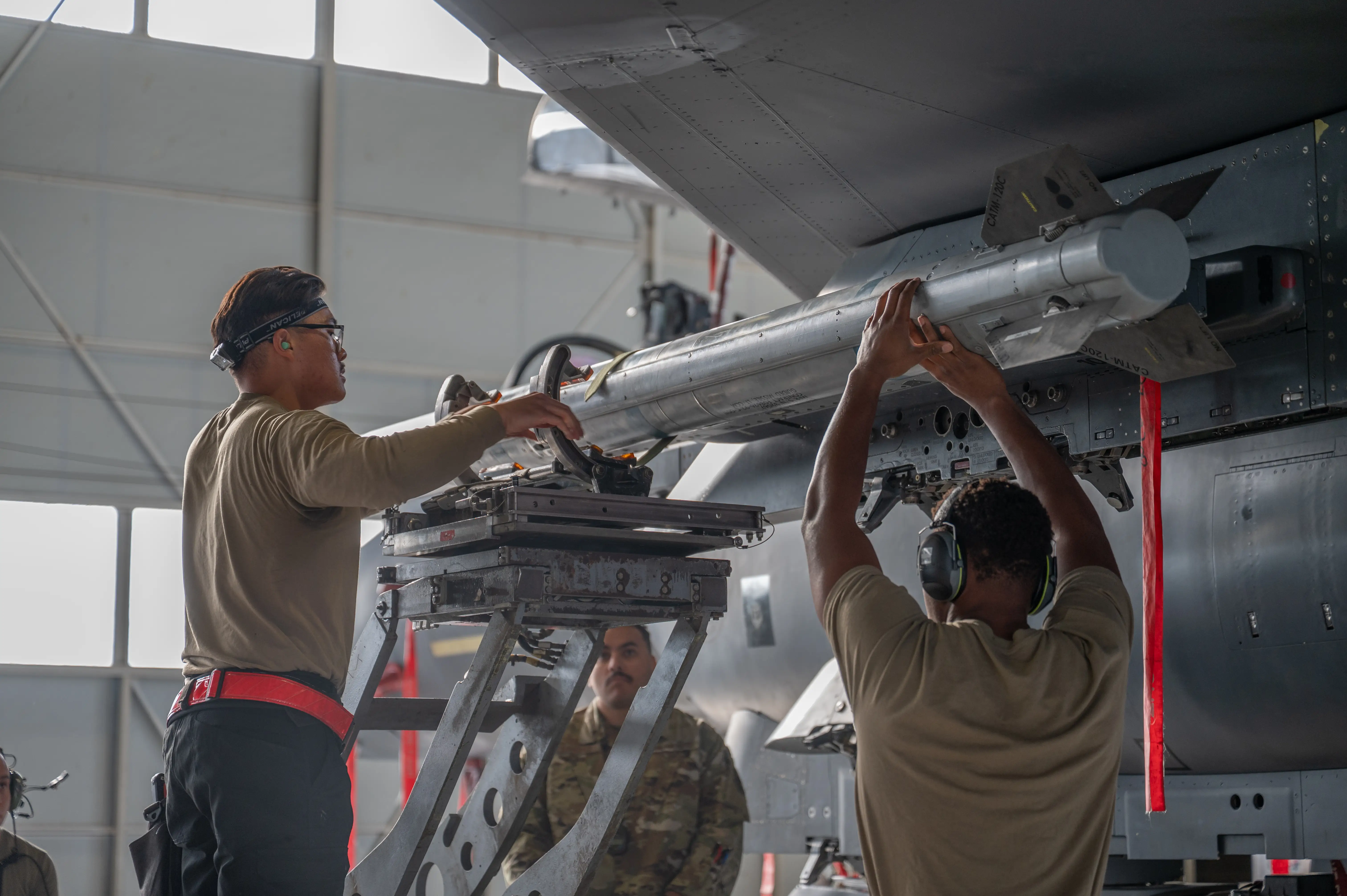 Loading an AIM-120 missile onto an F-15E Strike Eagle