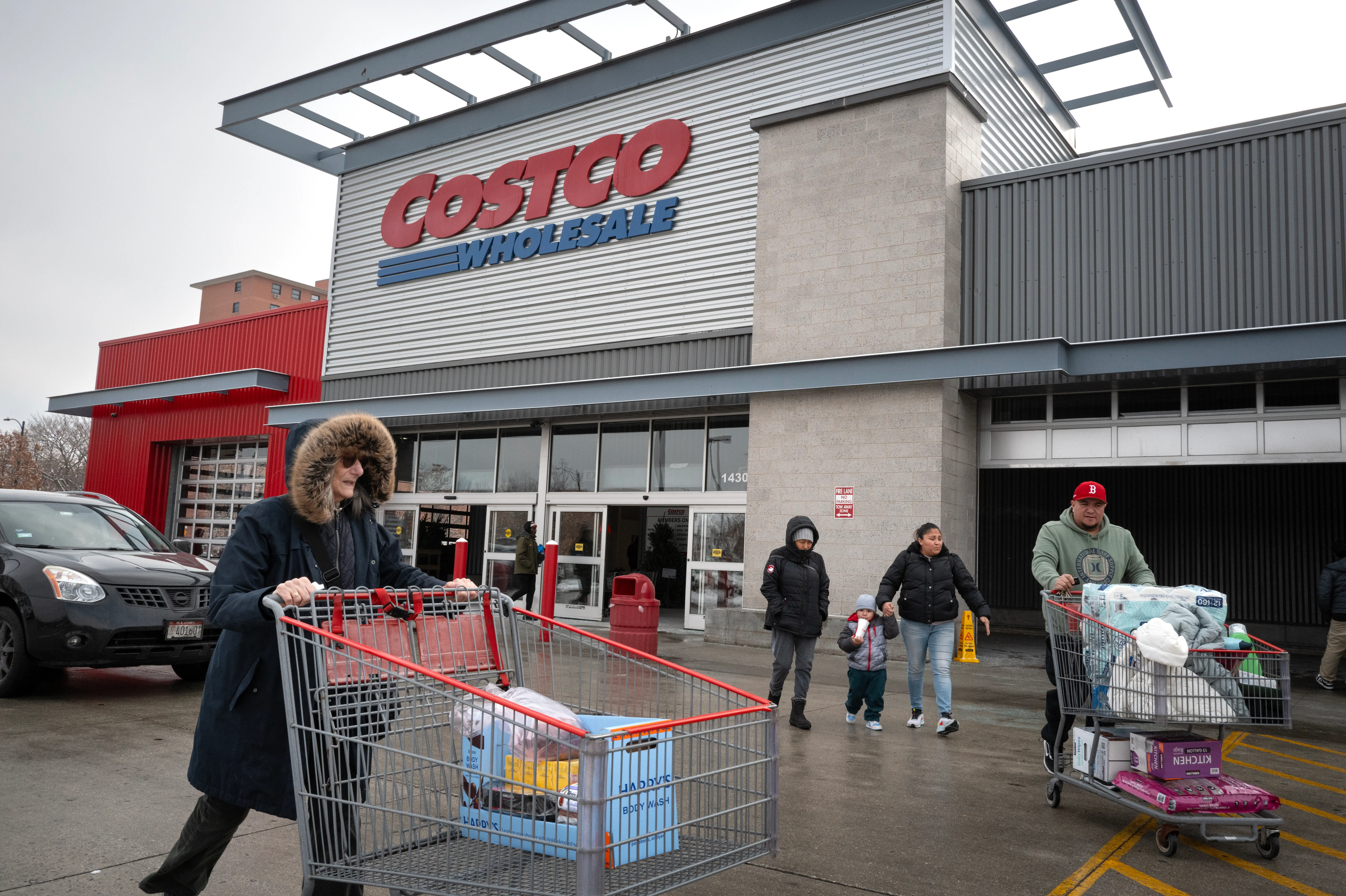 Customers walk in the parking lot outside a Costco store on December 02, 2025 in Chicago, Illinois.