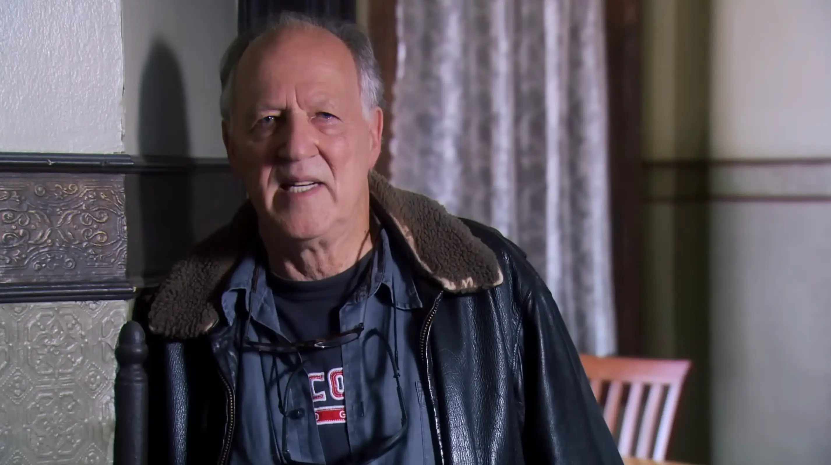 Werner Herzog leaning against a wall in a Parks and Rec episode