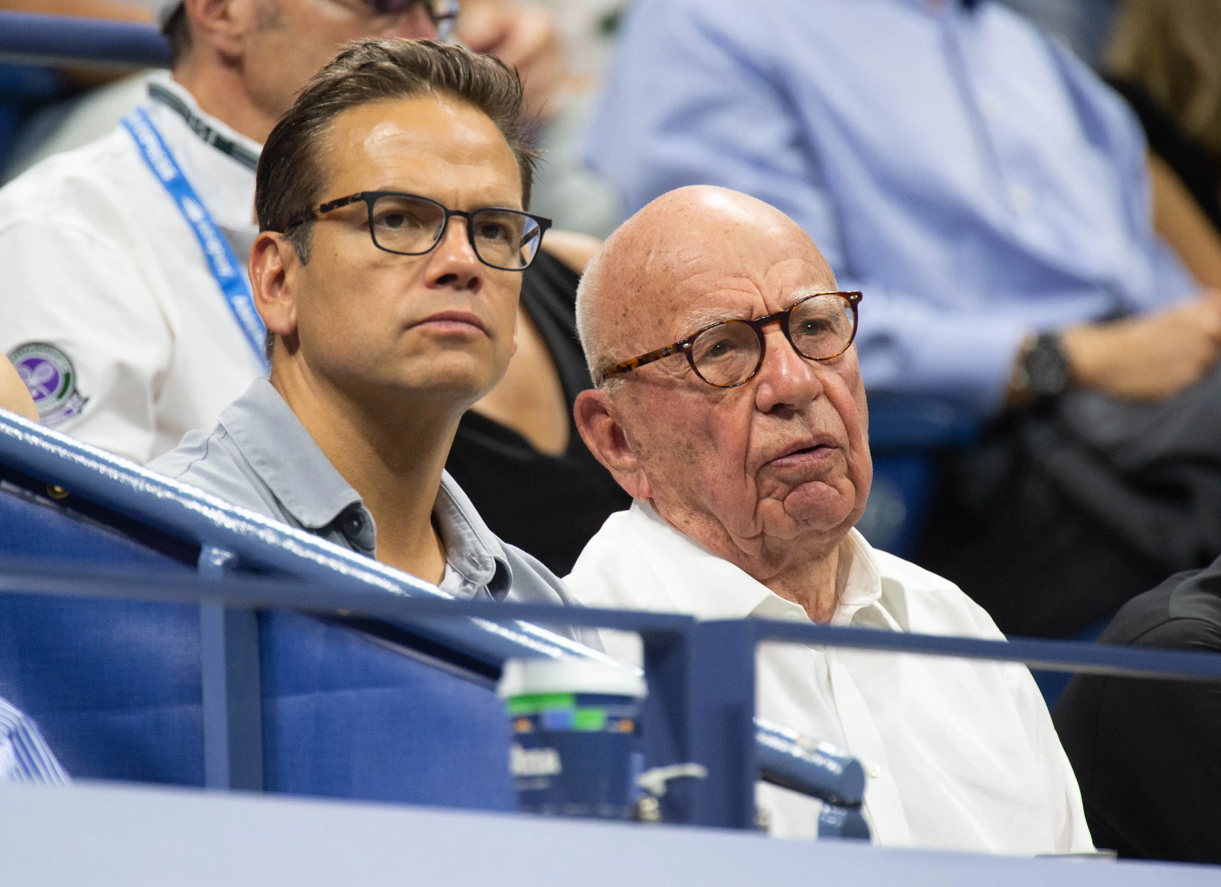 Lachlan and Rupert Murdoch watch a tennis match.
