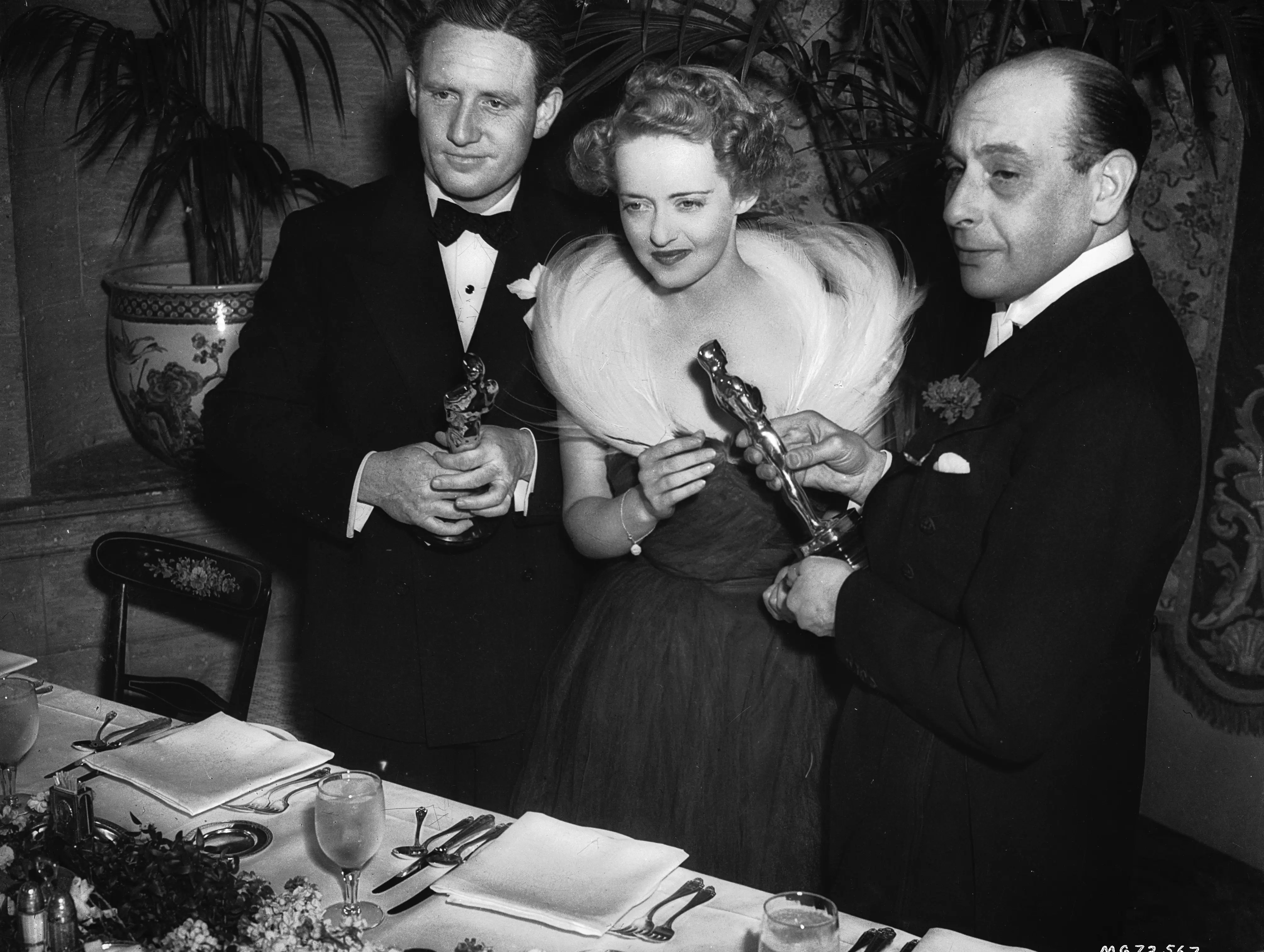 Spencer Tracy, Bette Davis, and another guest at the 1939 Oscars.