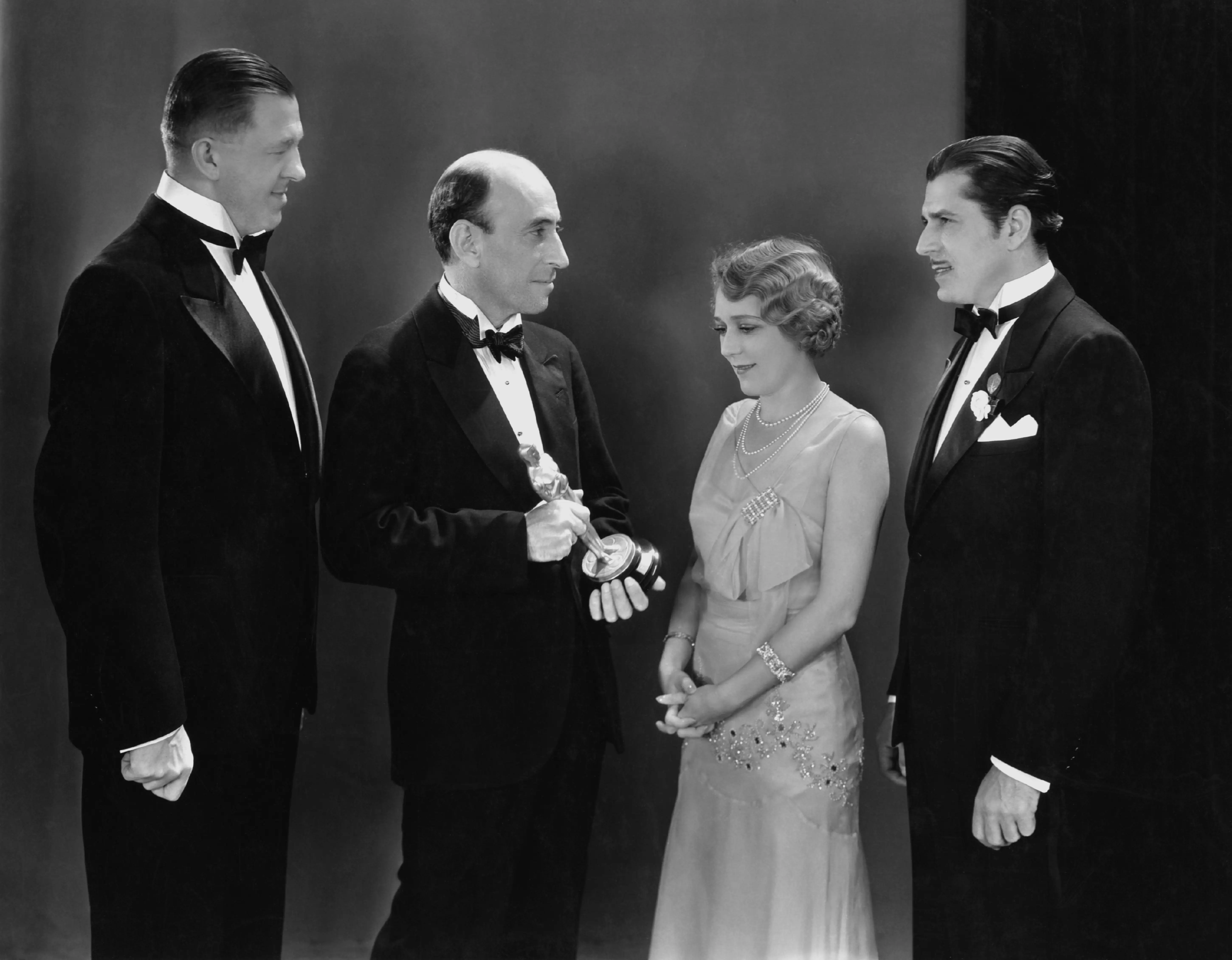Hanns Kraly, William C. deMille, Mary Pickford, and Warner Baxter.