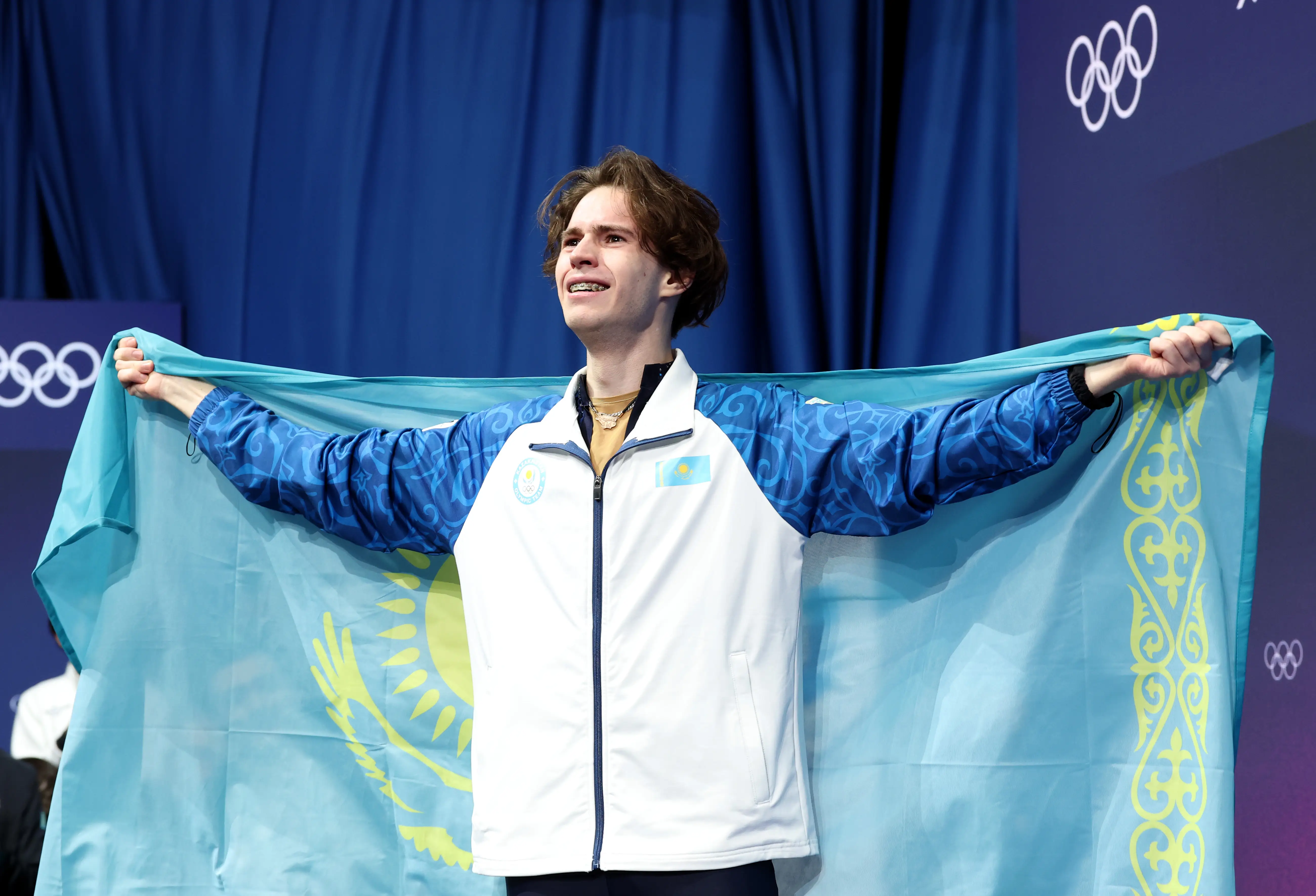 Mikhail Shaidorov of Team Kazakhstan celebrates winning gold in the Men Single Skating on day seven of the Milano Cortina 2026 Winter Olympic games at Milano Ice Skating Arena on February 13, 2026 in Milan, Italy