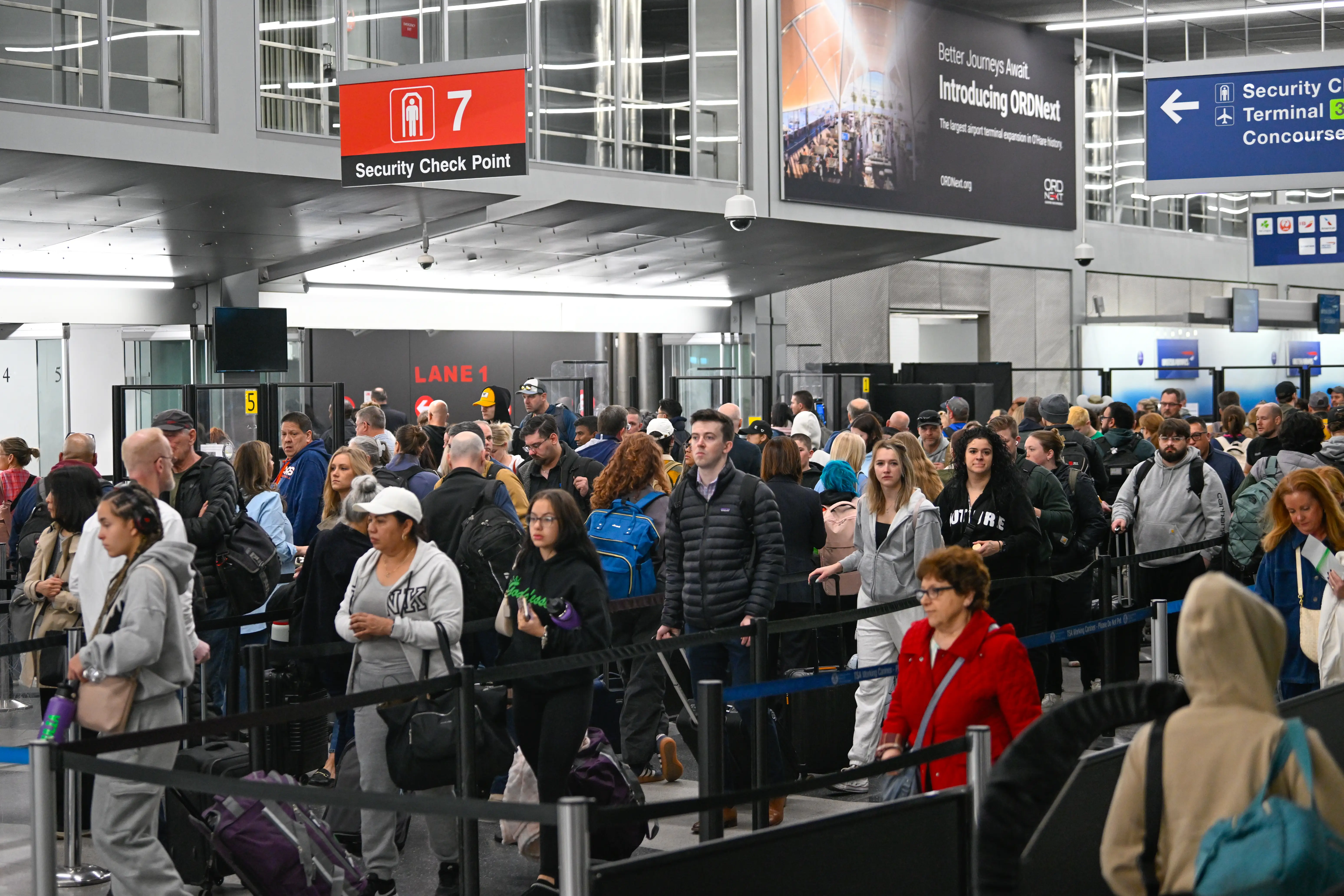 Travelers wait in line at Chicago O'Hare airport