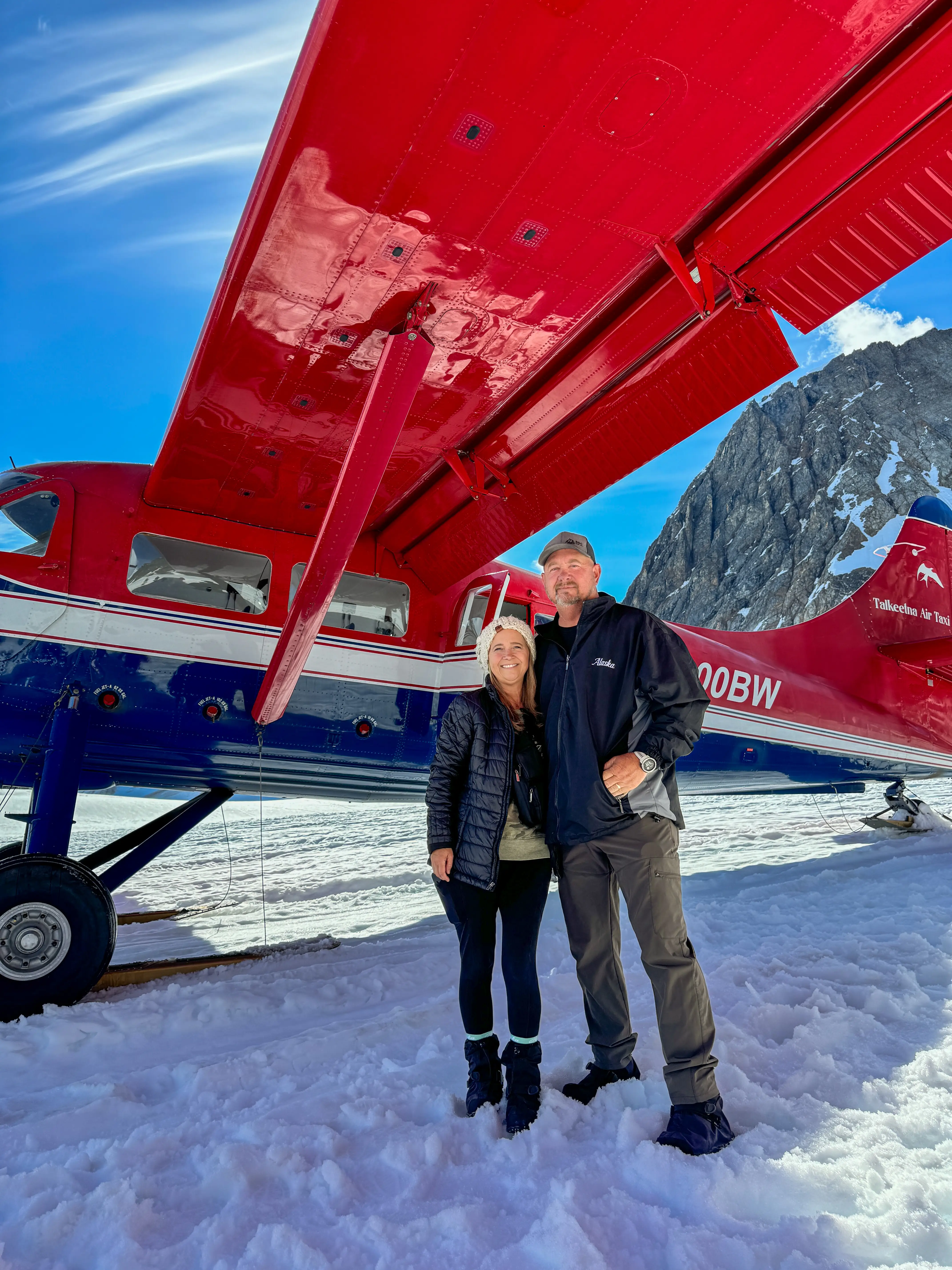 Patty and Shane Gill are next to a plane in Alaska