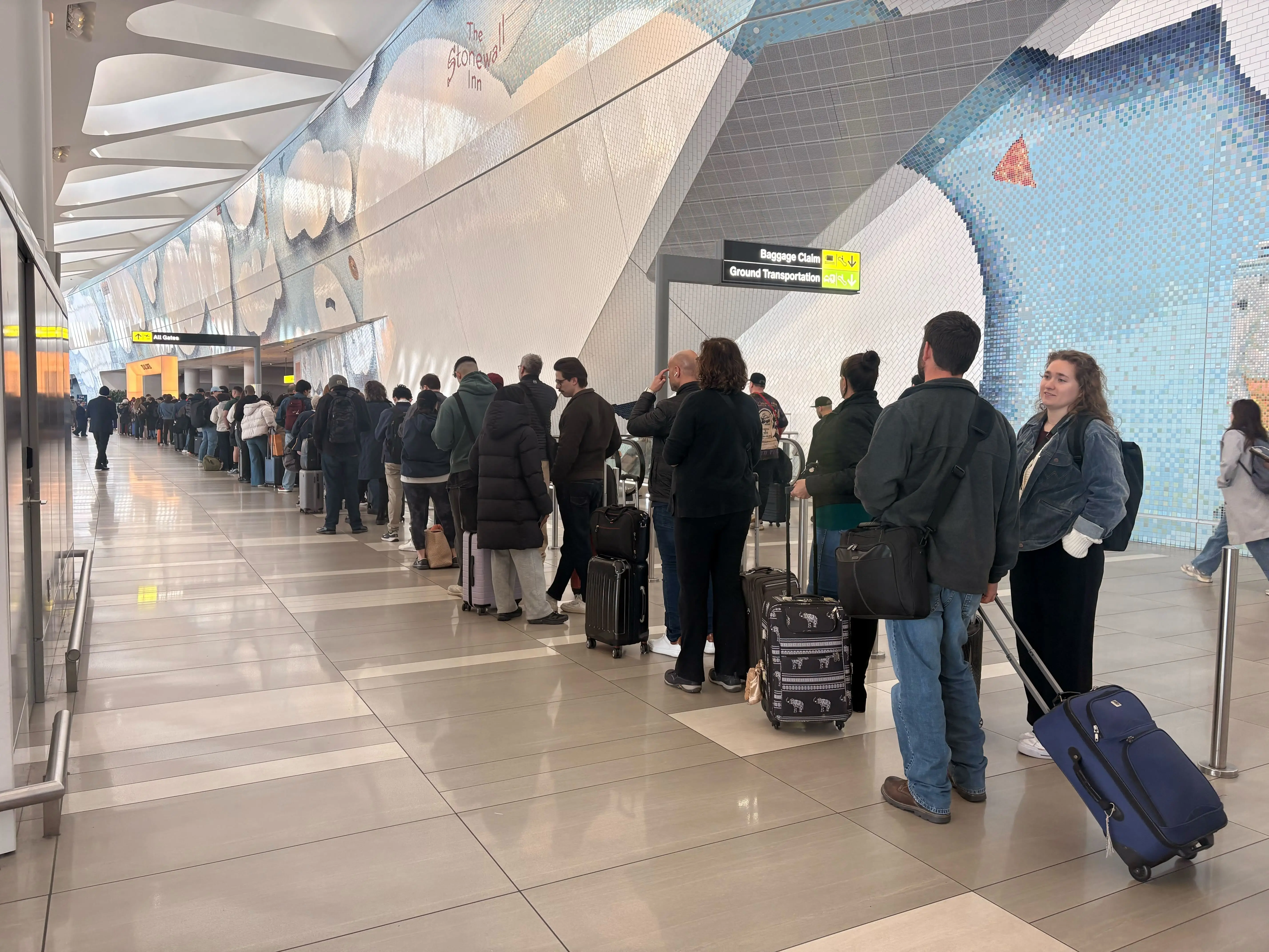 Travelers wait in line at New York's LaGuardia airport.