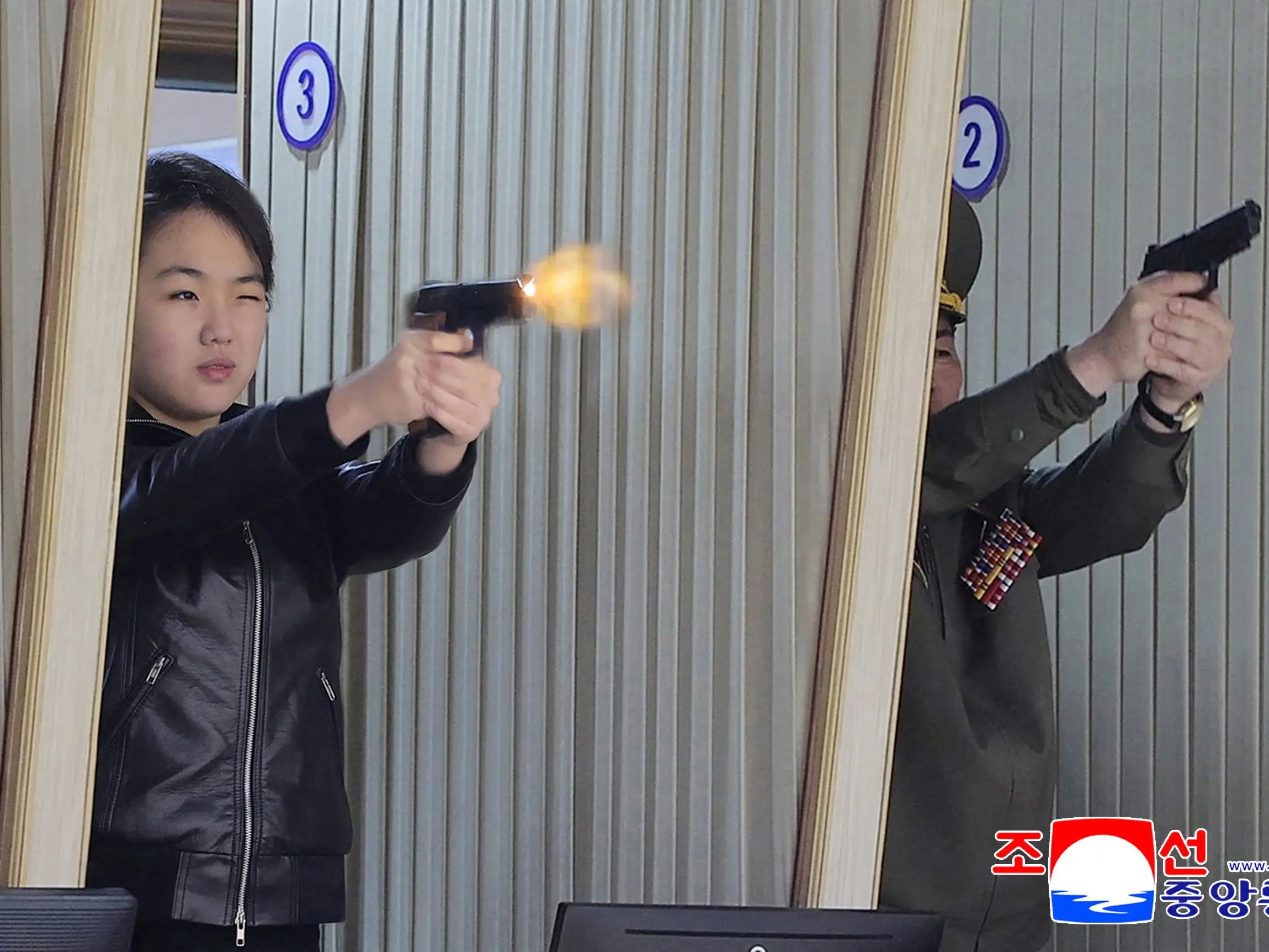 Kim Ju Ae fires a pistol.