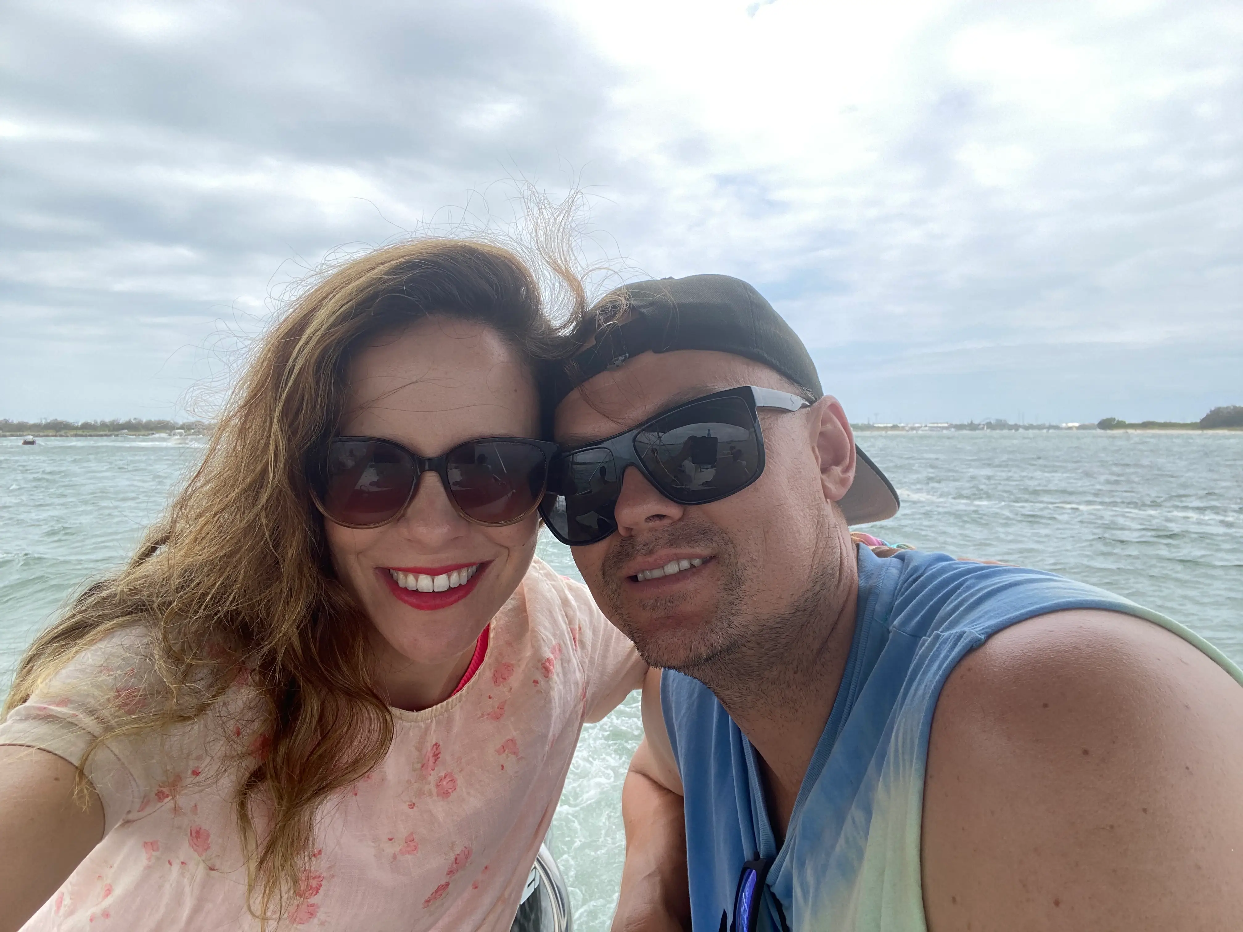 Two people in sunglasses smiling