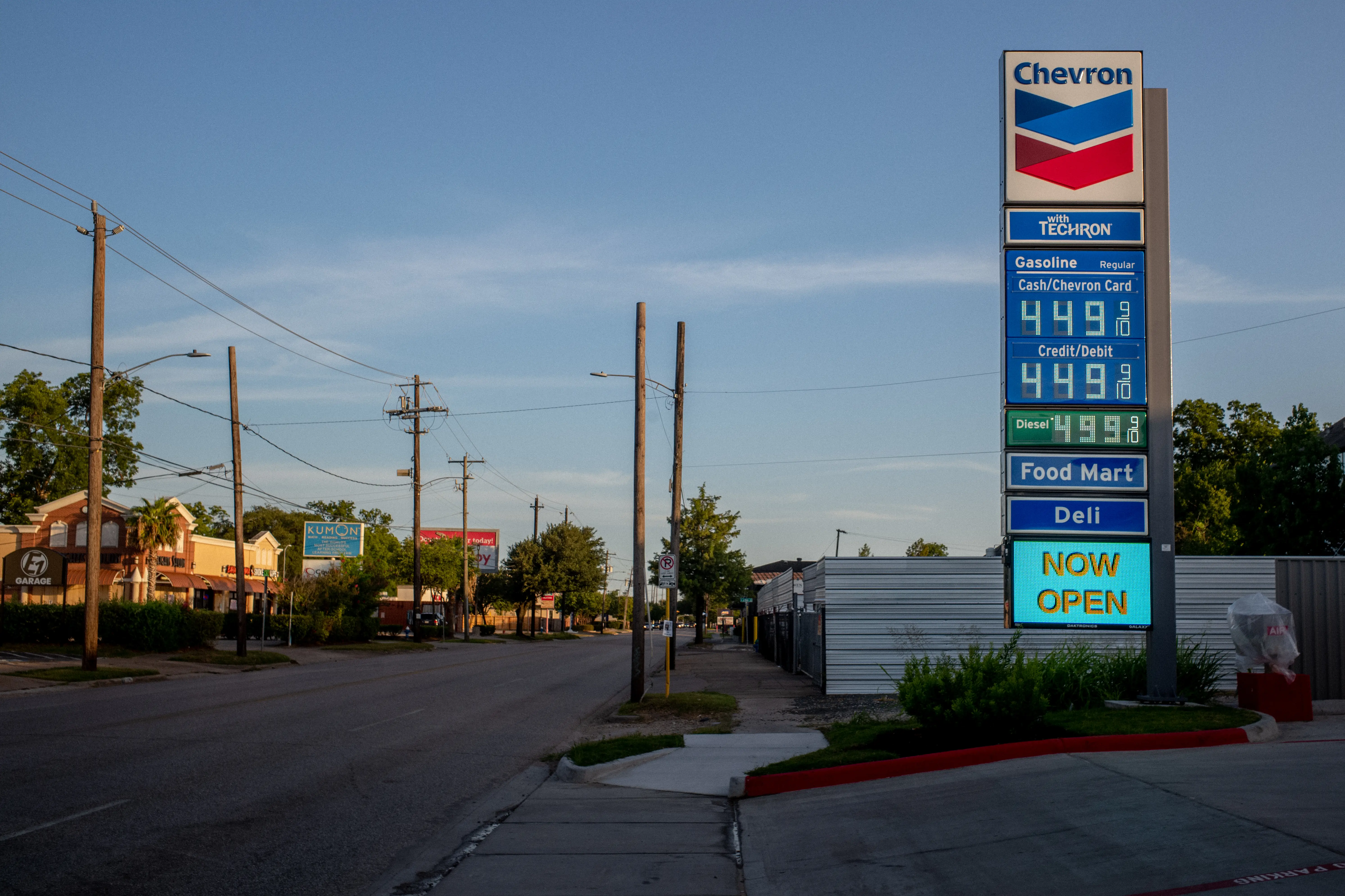 A Chevron gas station's pricing sign is next to an empty street. The station is showing $4.49 per gallon for regular gas.