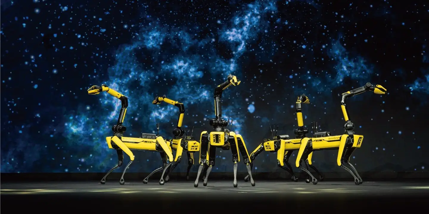A row of yellow quadruped robots