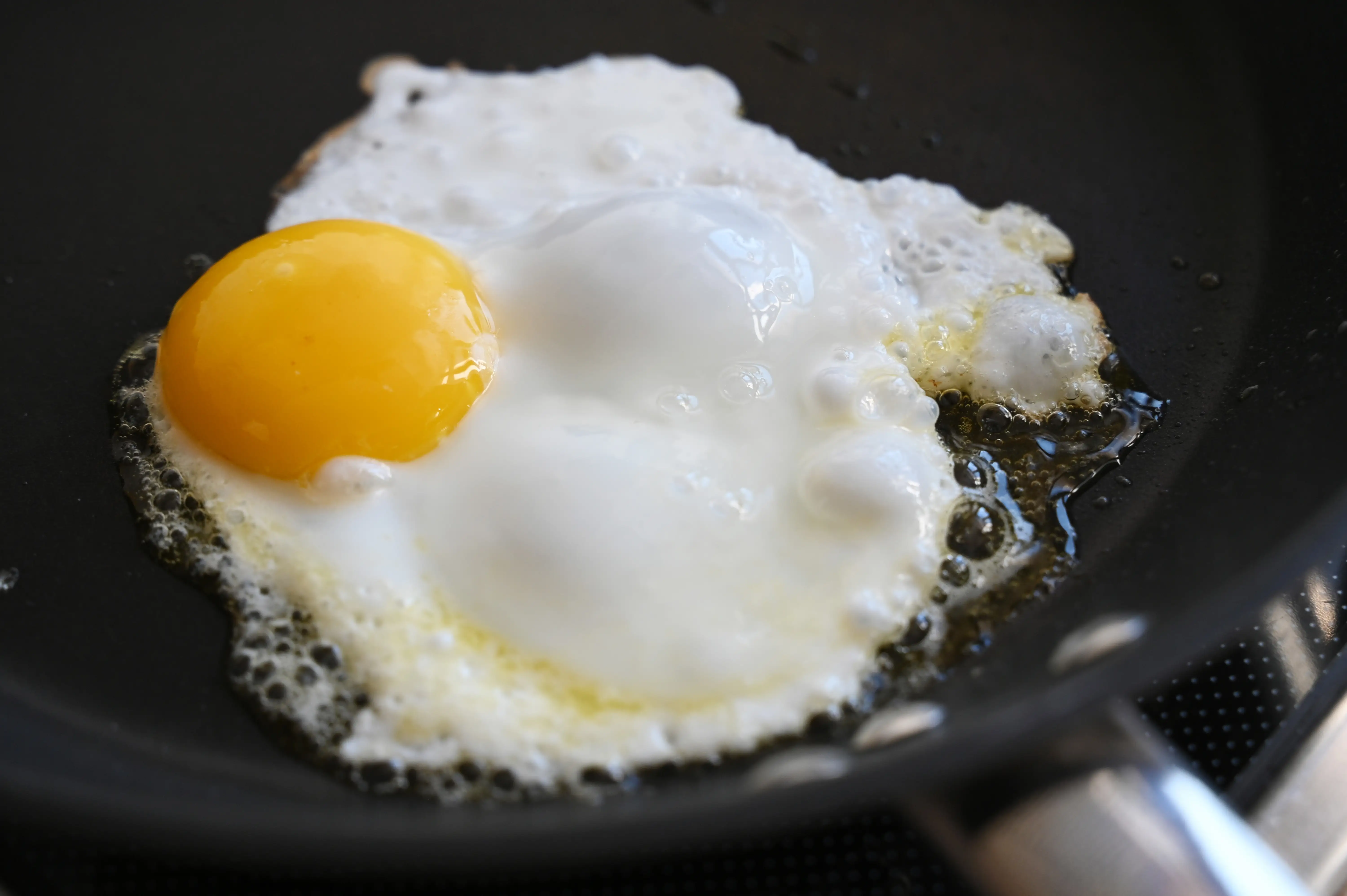 An egg frying in a pan